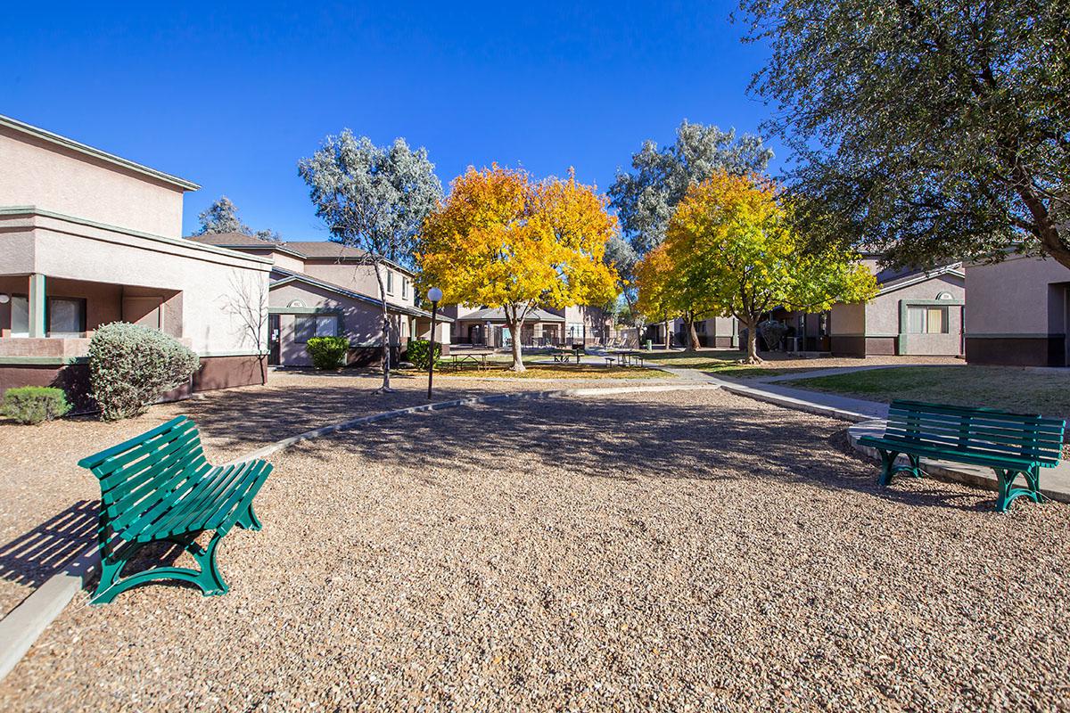 an empty park bench next to a building