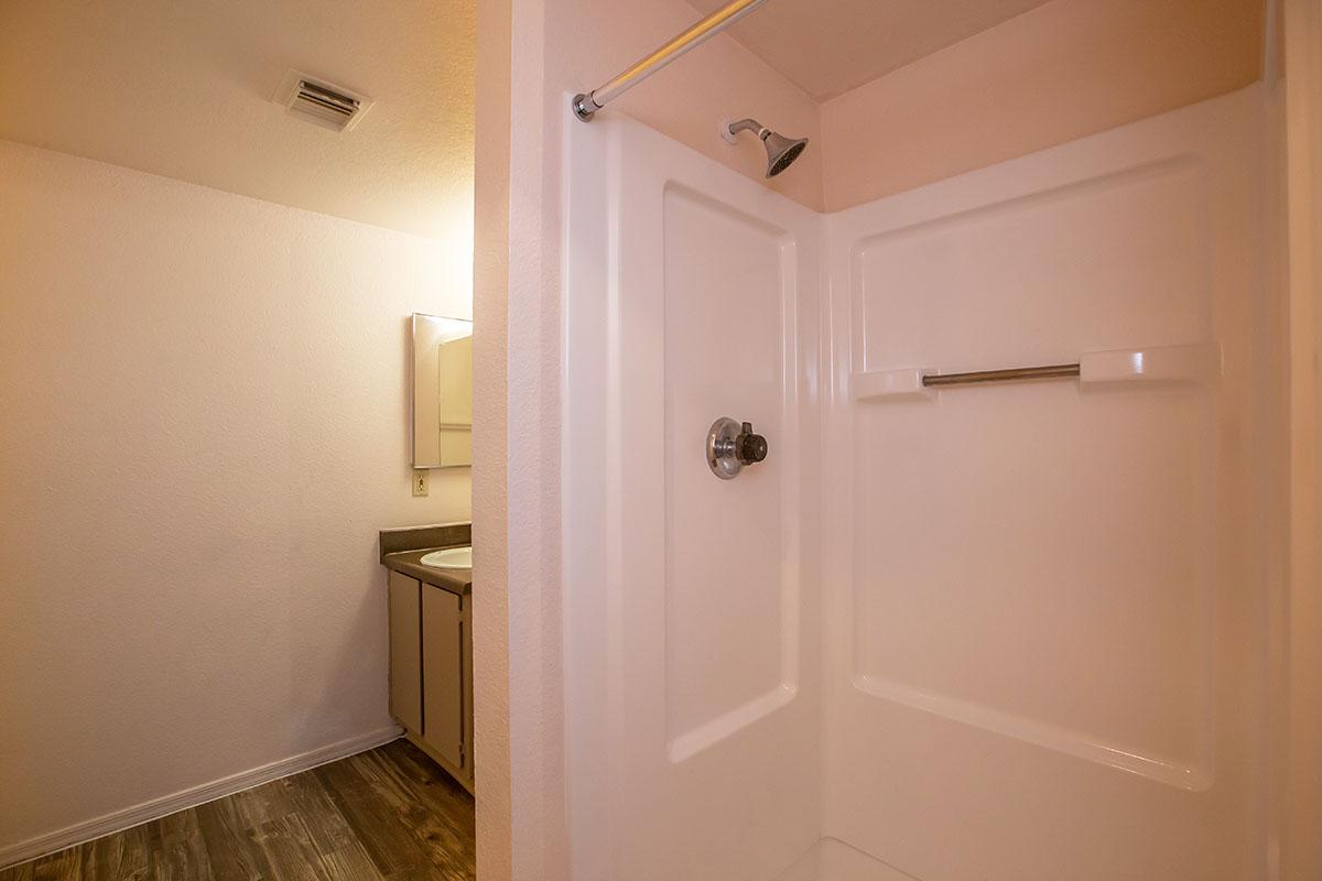 a white tub sitting next to a shower