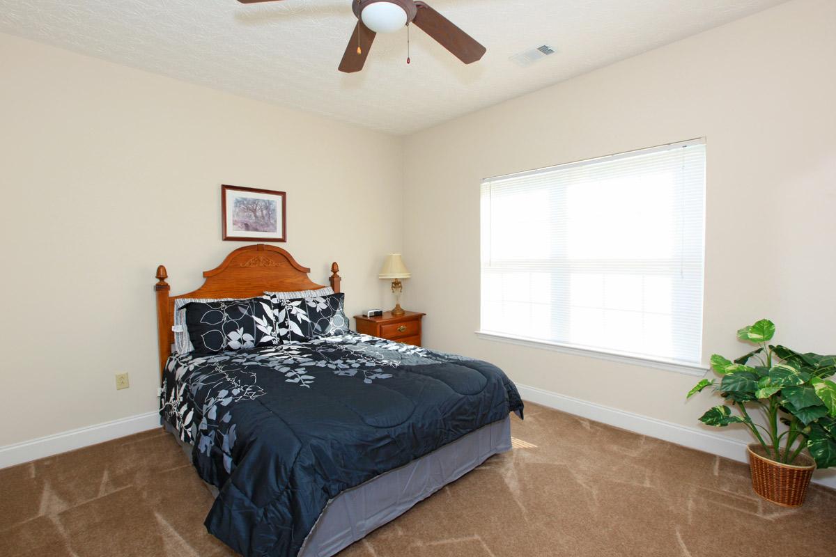 a bedroom with a bed in a room