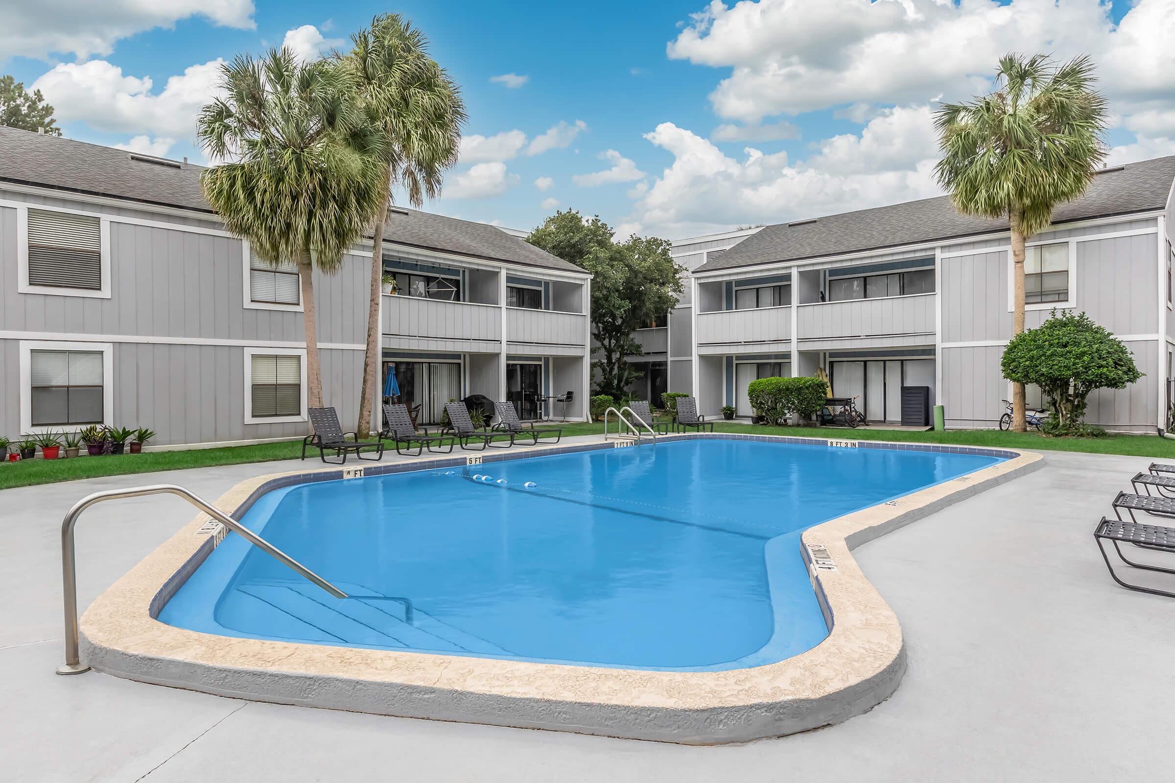 a house with a pool in front of a building