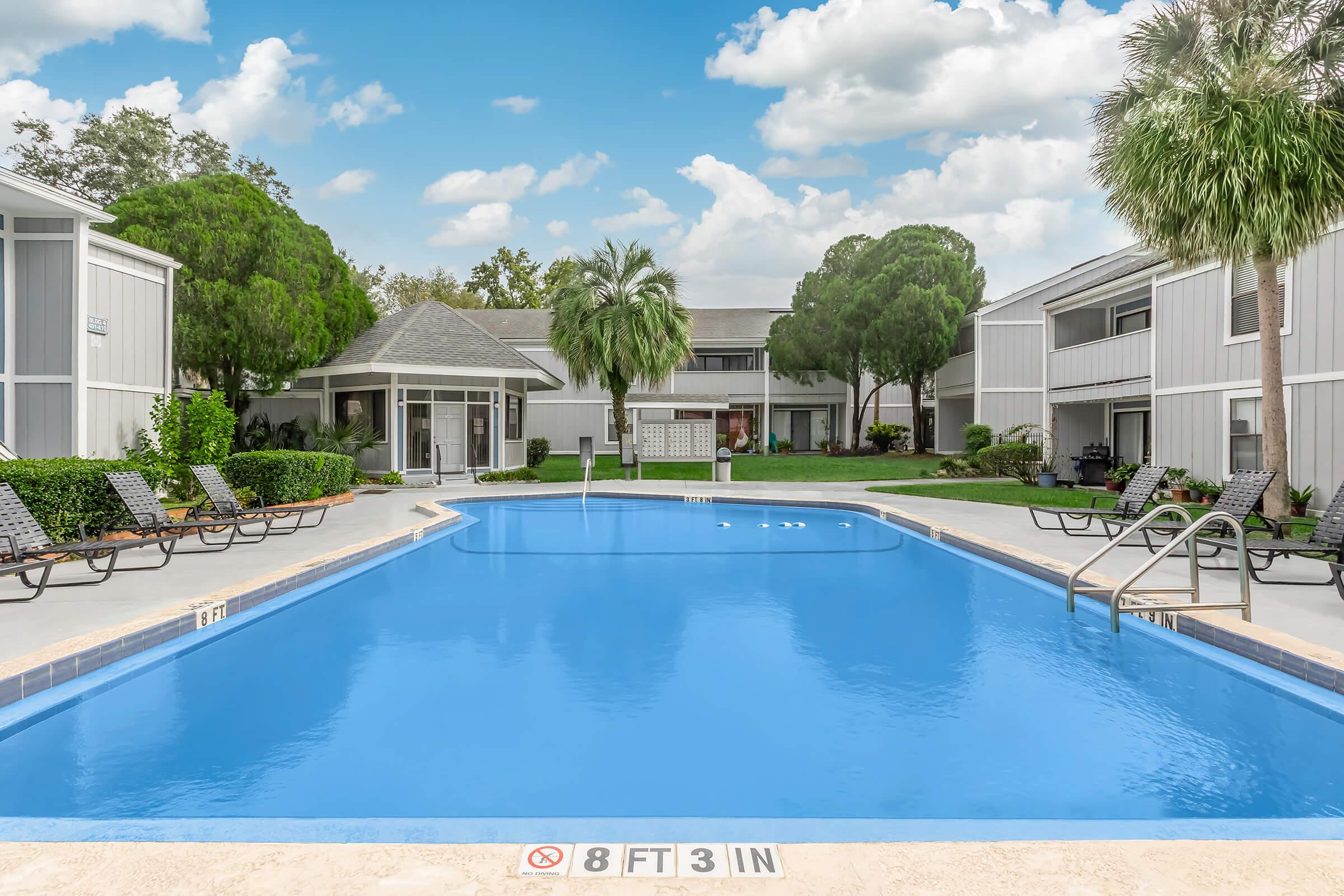 a house with a pool outside of a building