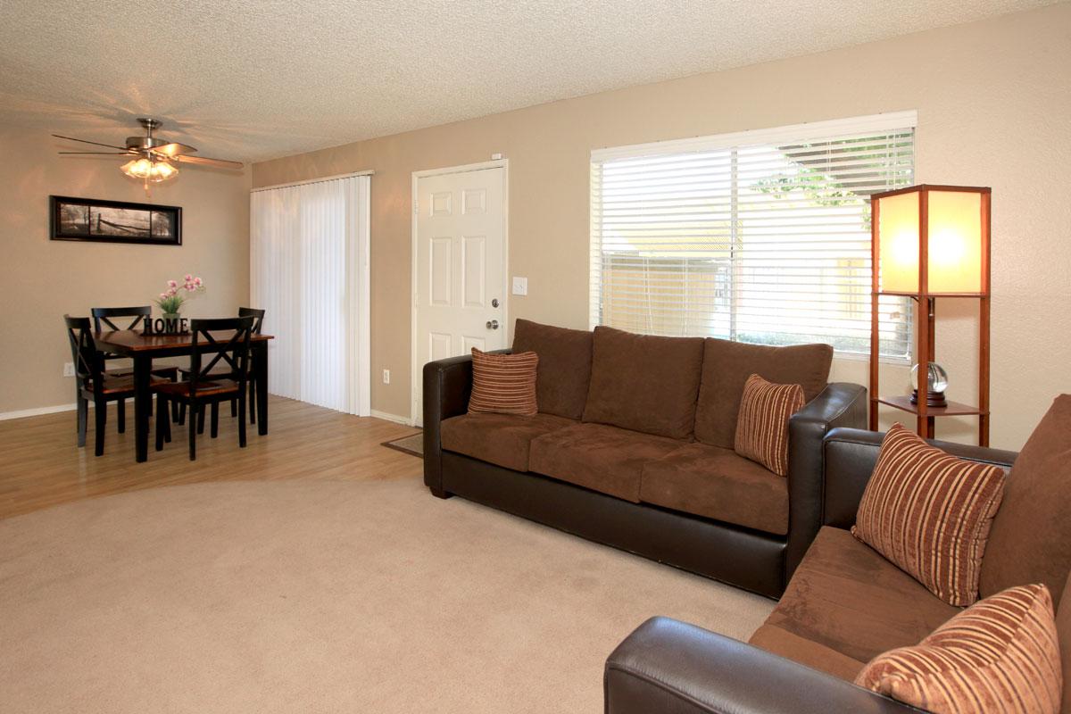 a living room filled with furniture and a flat screen tv