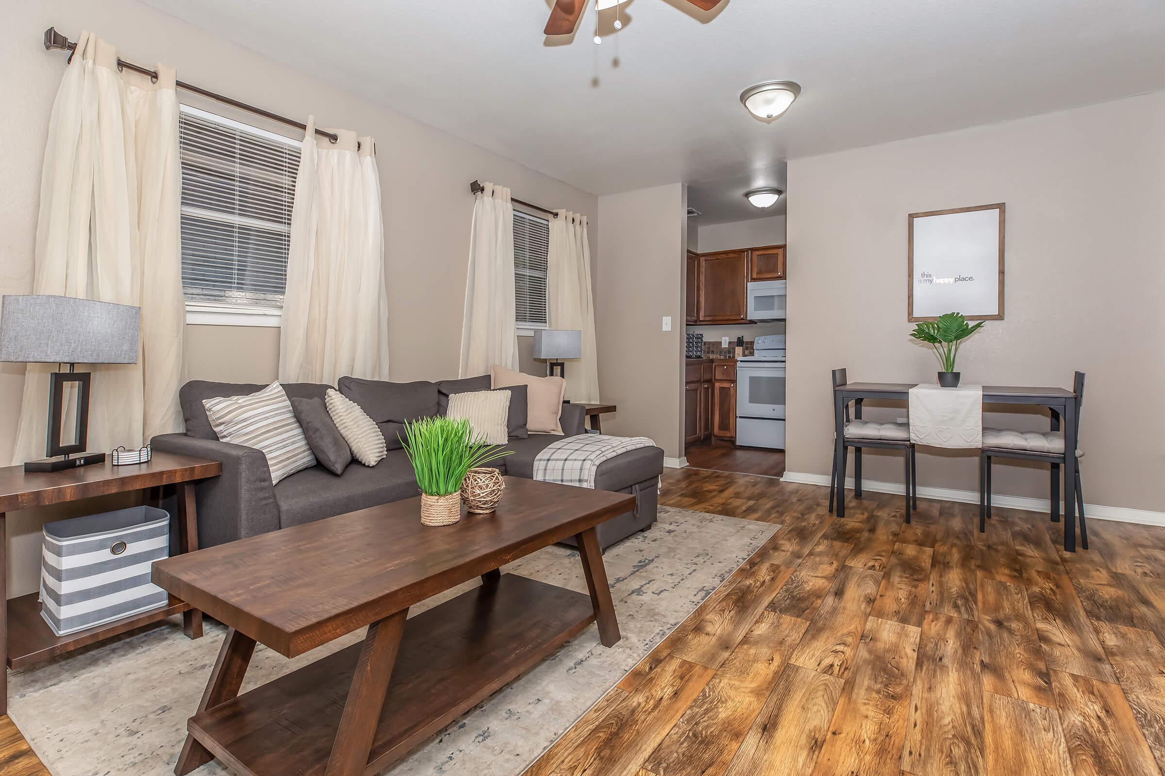 a living room filled with furniture and a wood floor