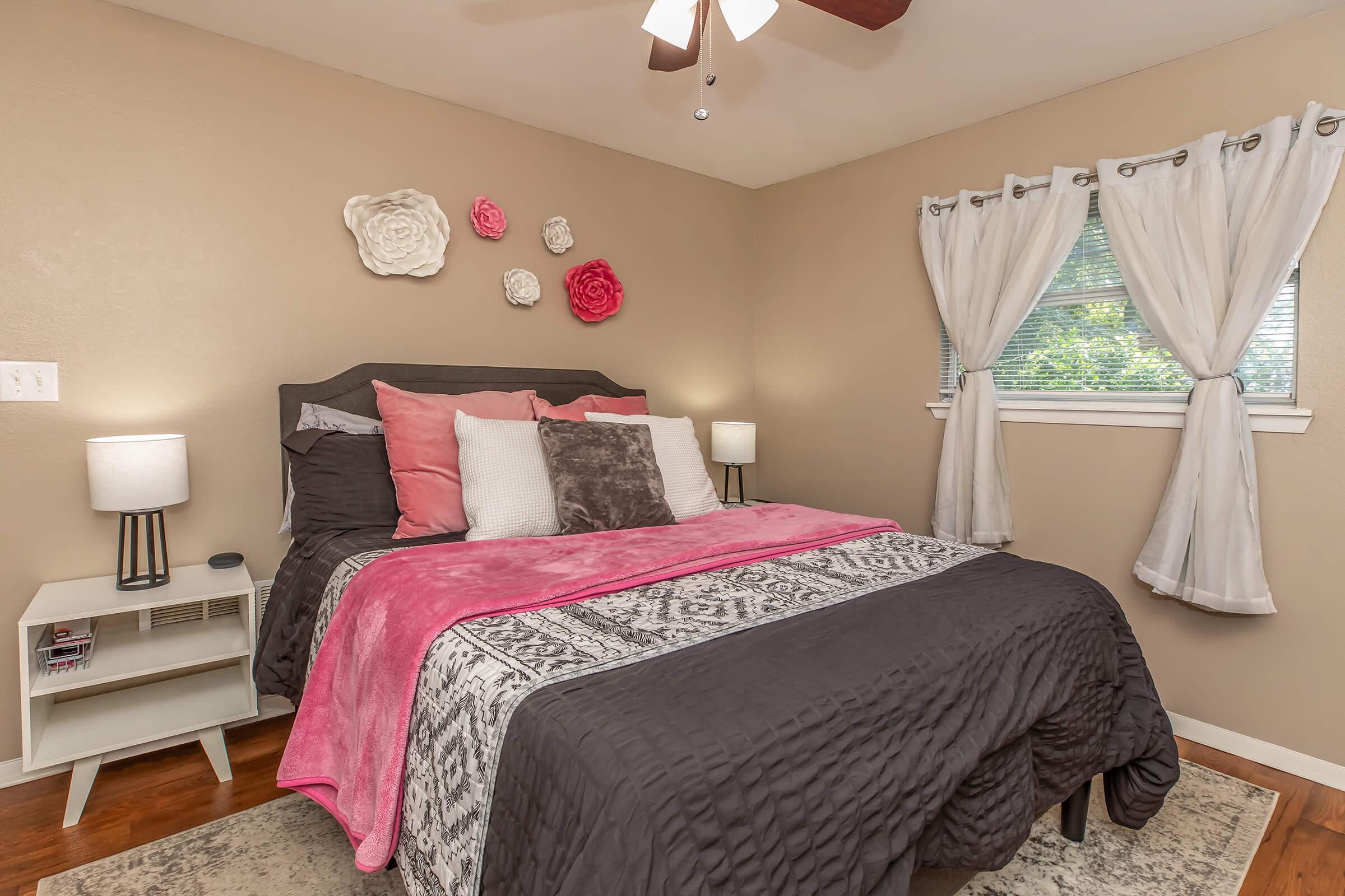 a bedroom with a bed and desk in a room