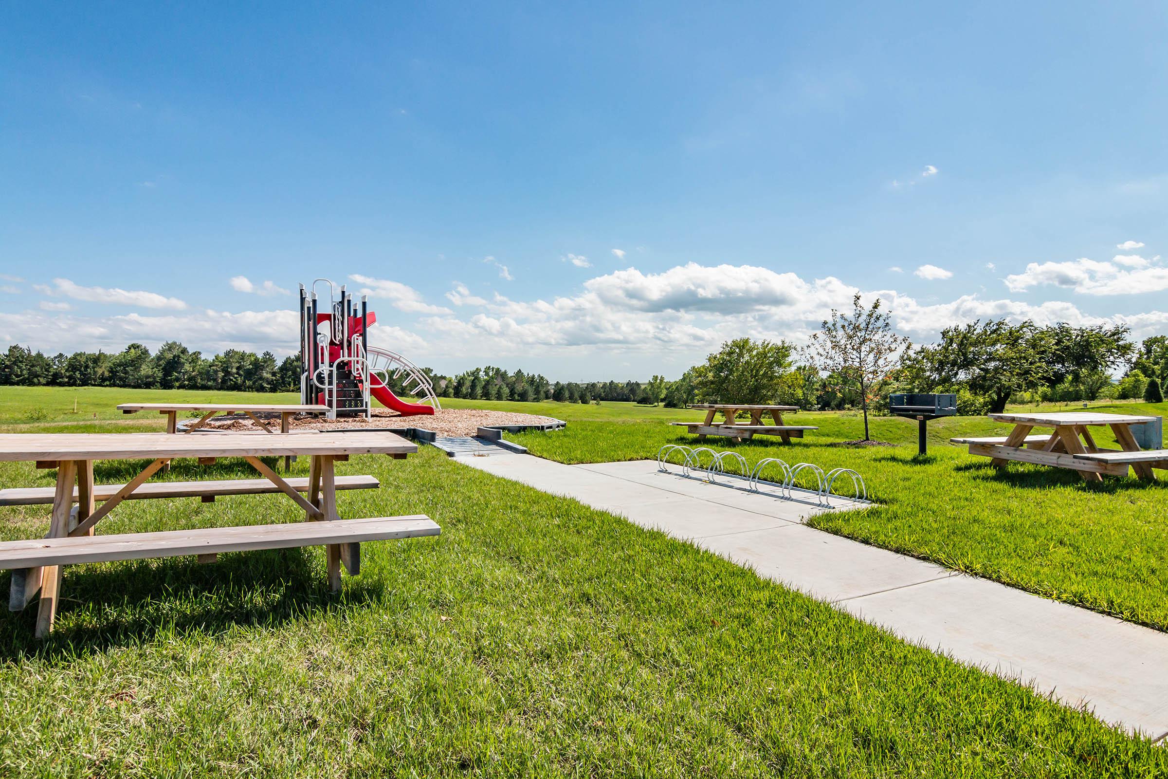 a bench in a grassy field