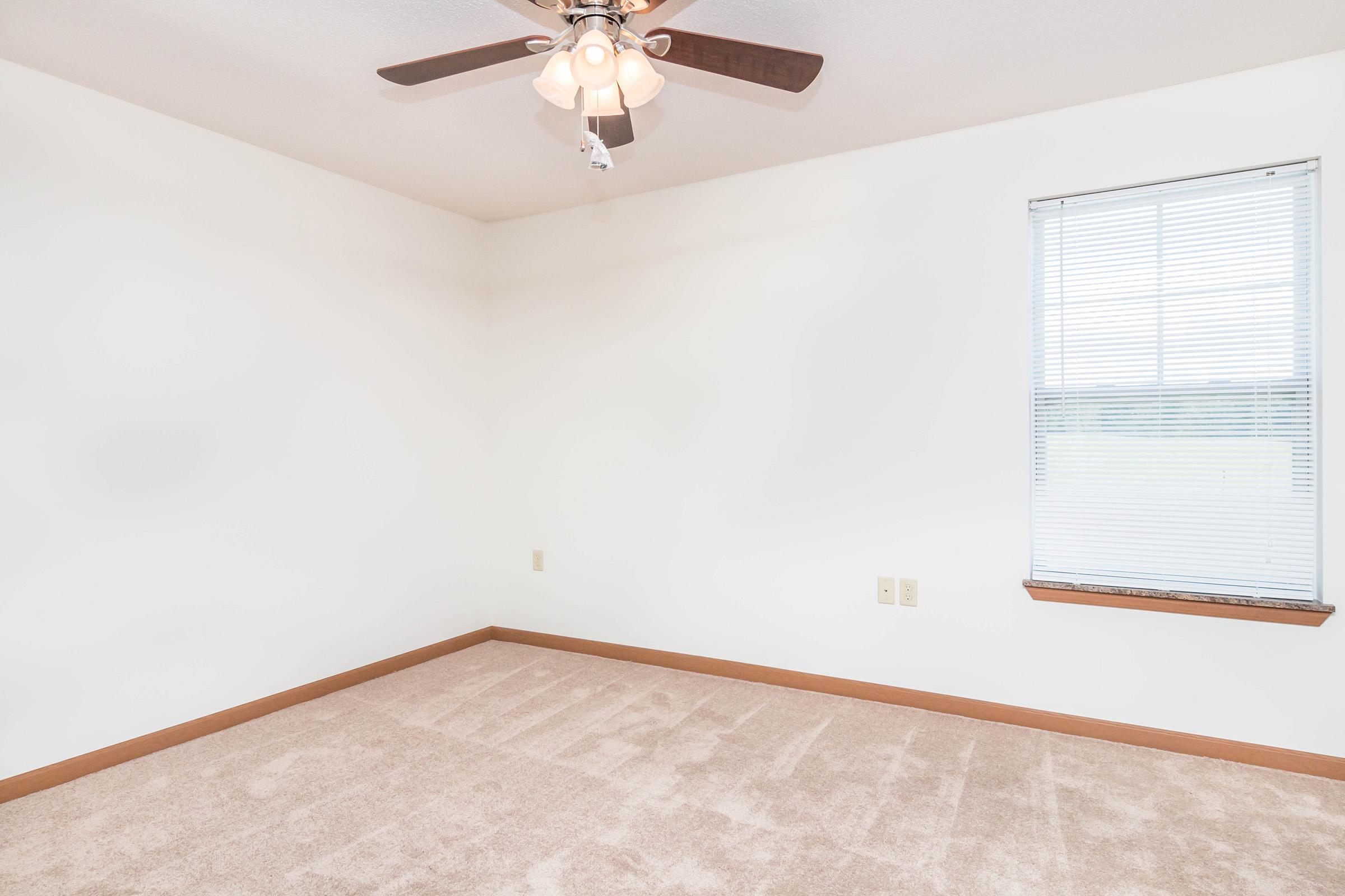 a bedroom with a bed and desk in a small room