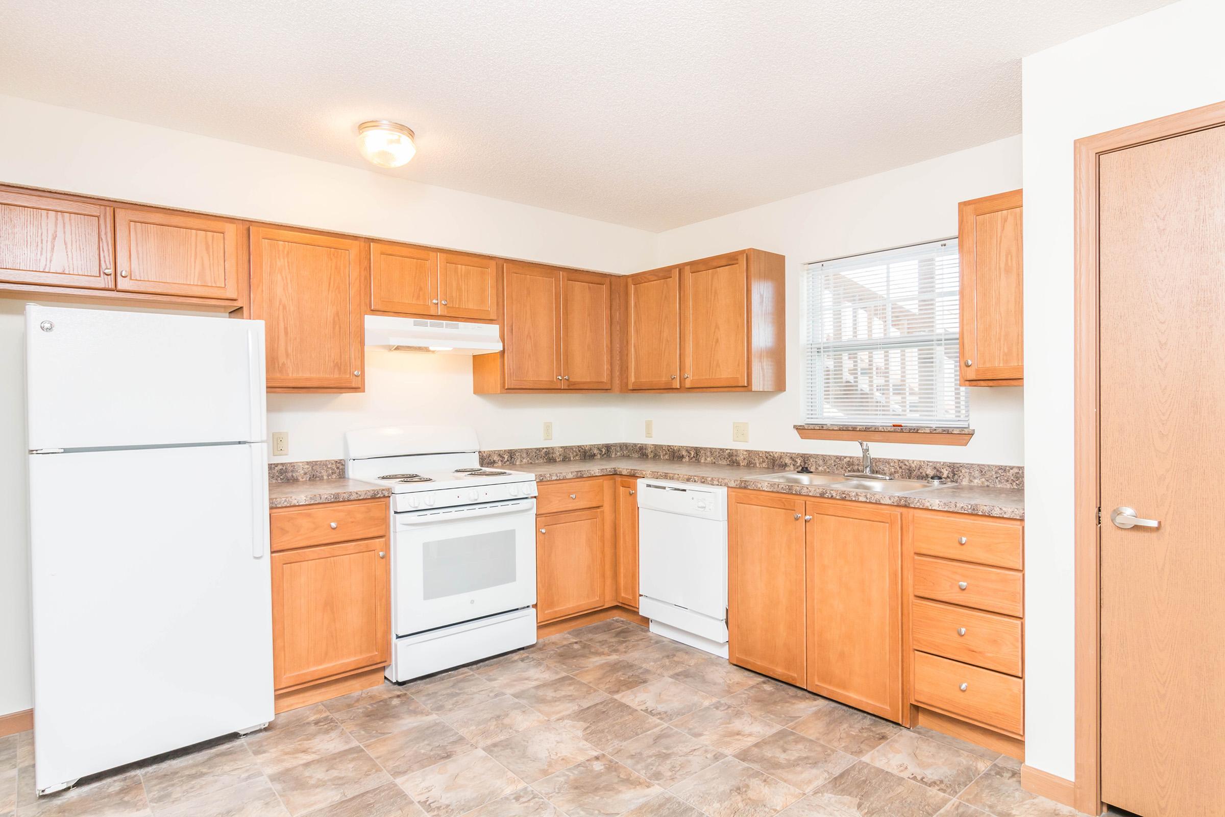 a kitchen with a stove and a refrigerator