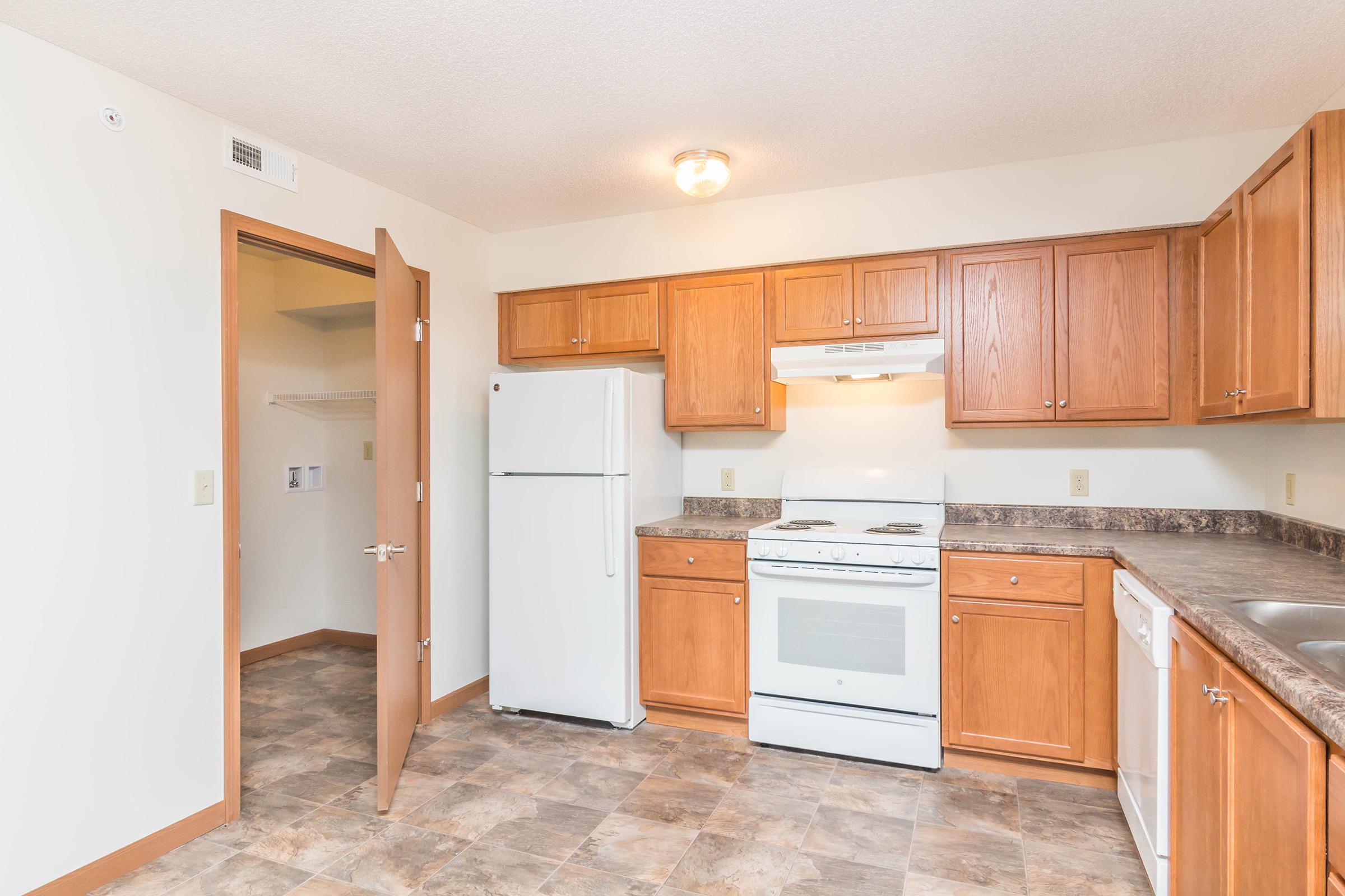 a kitchen with stainless steel appliances and wooden cabinets