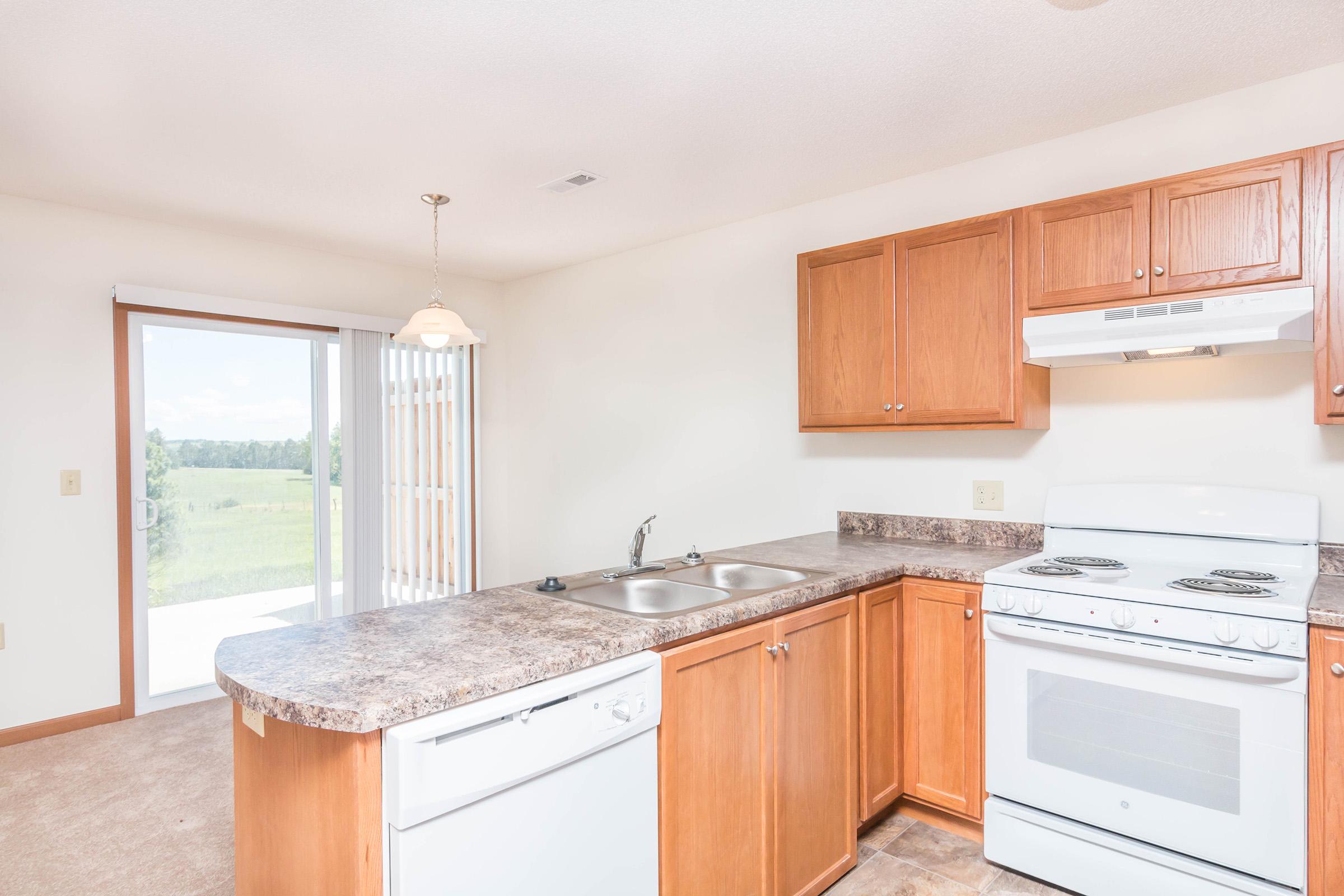 a kitchen with stainless steel appliances and wooden cabinets