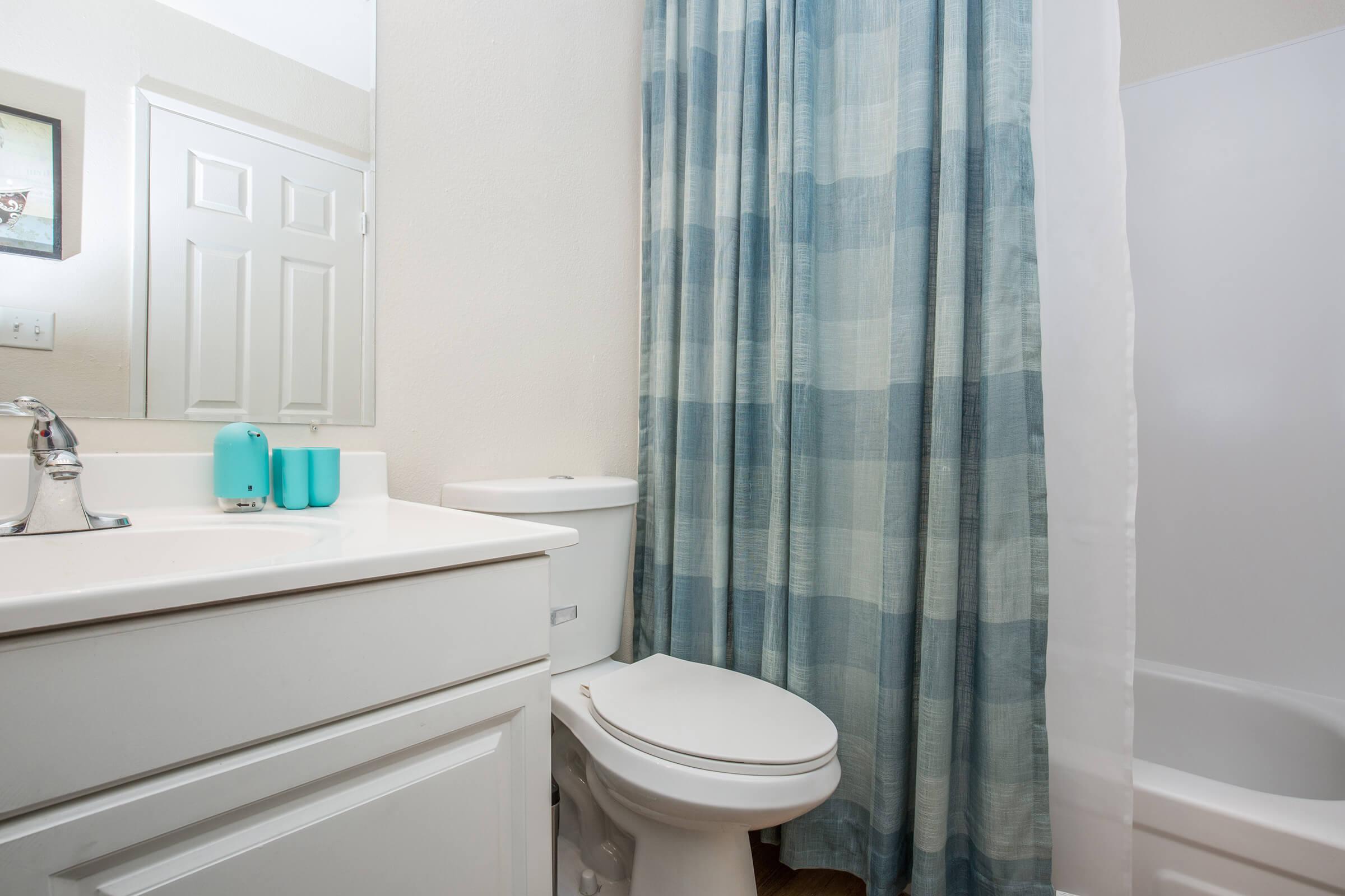 a white tub sitting next to a shower curtain