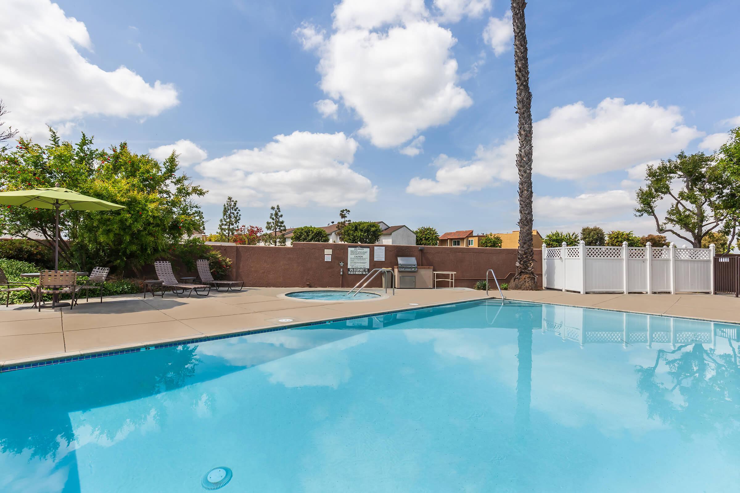 The community pool and the community spa with a green umbrella