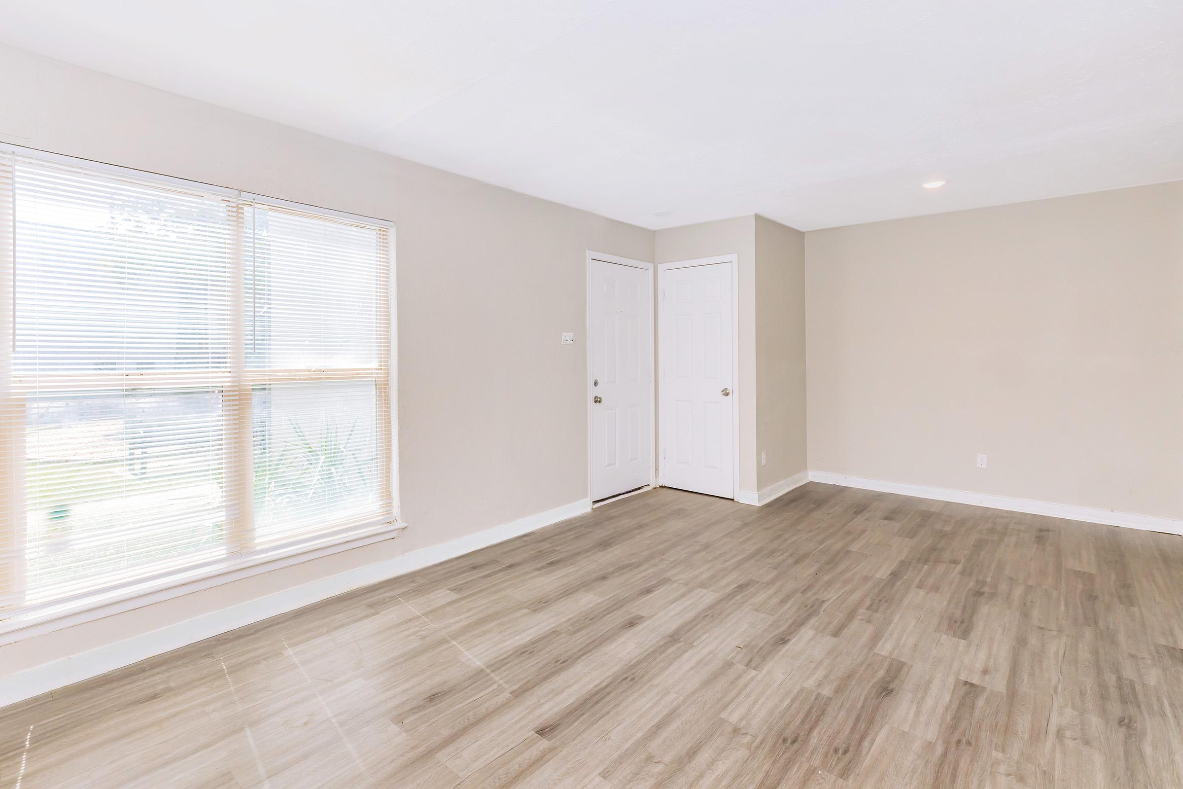 a large empty room with a wooden floor