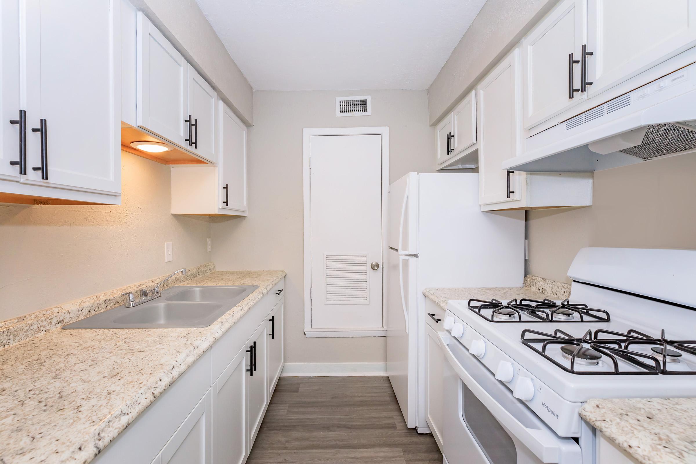 a kitchen with a stove and a sink