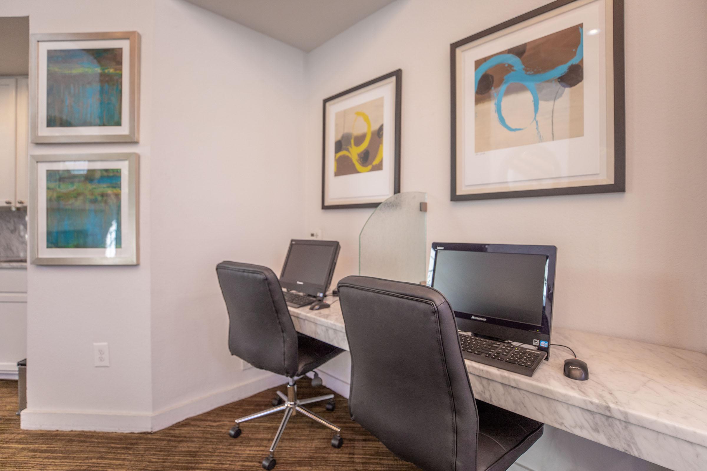 computers on a desk in the community business center 