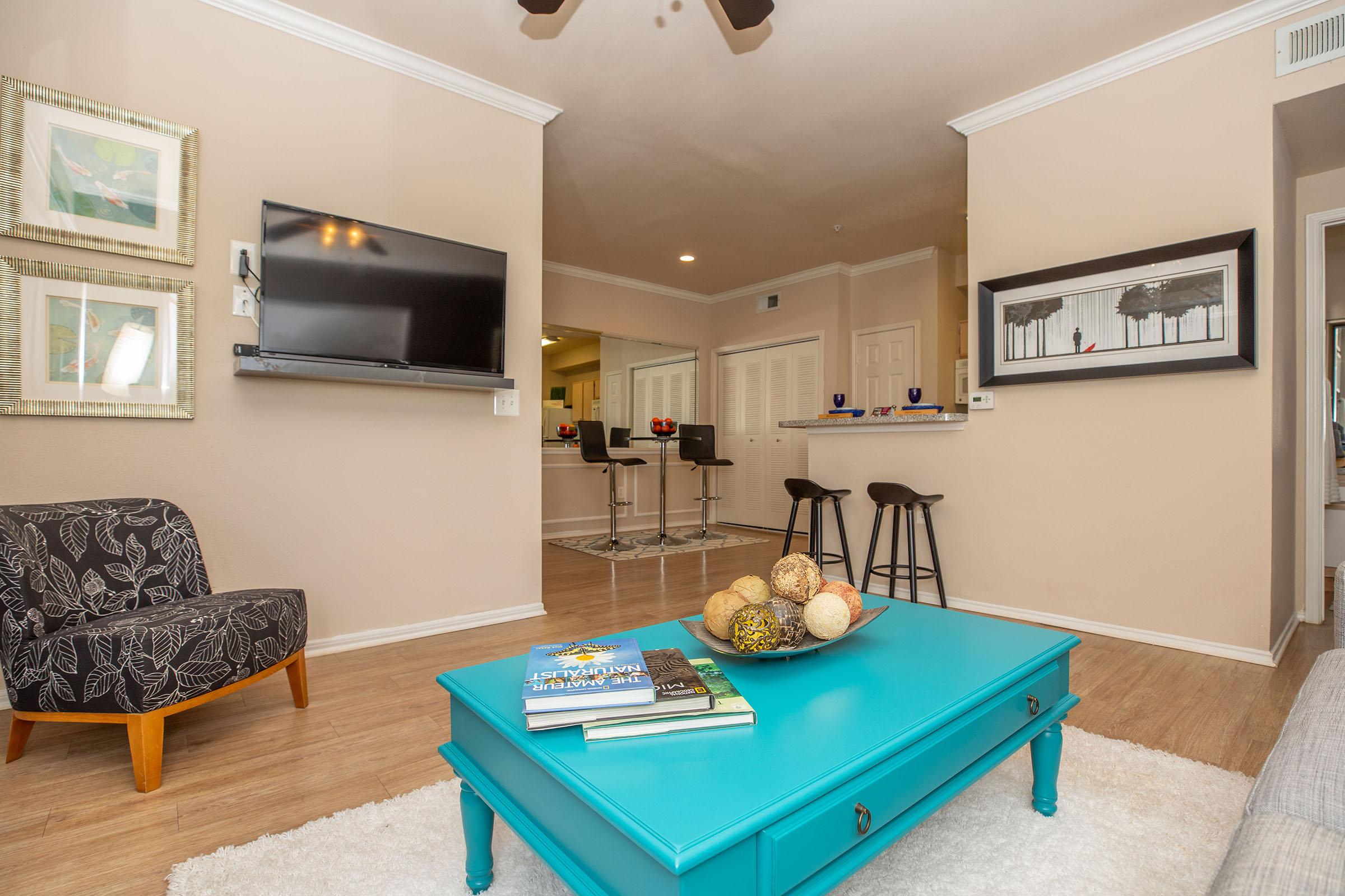 a living room with a teal coffee table