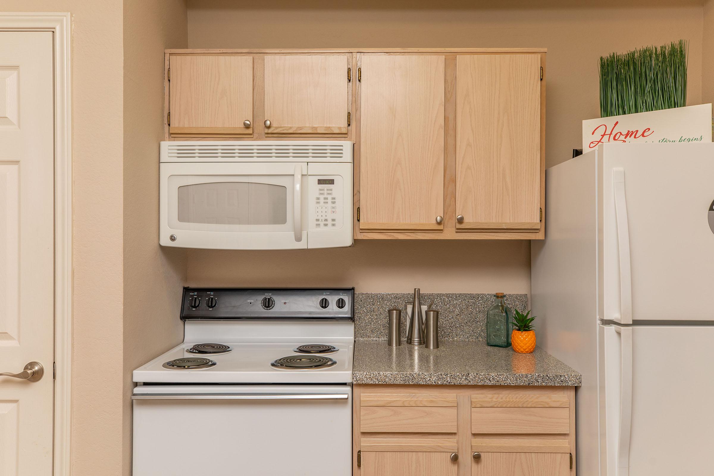 a kitchen with wooden cabinets