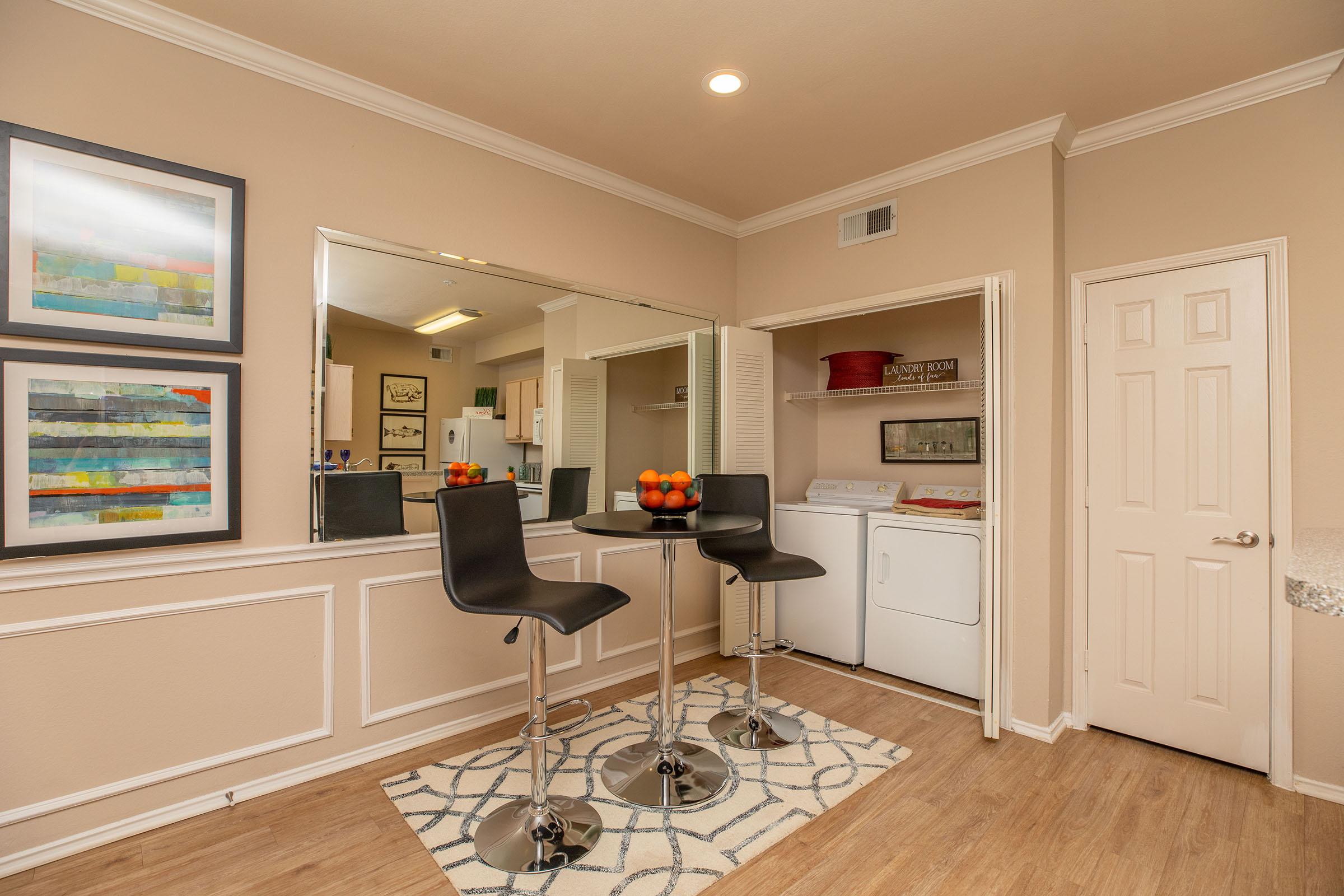 a dining room with a washer and dryer