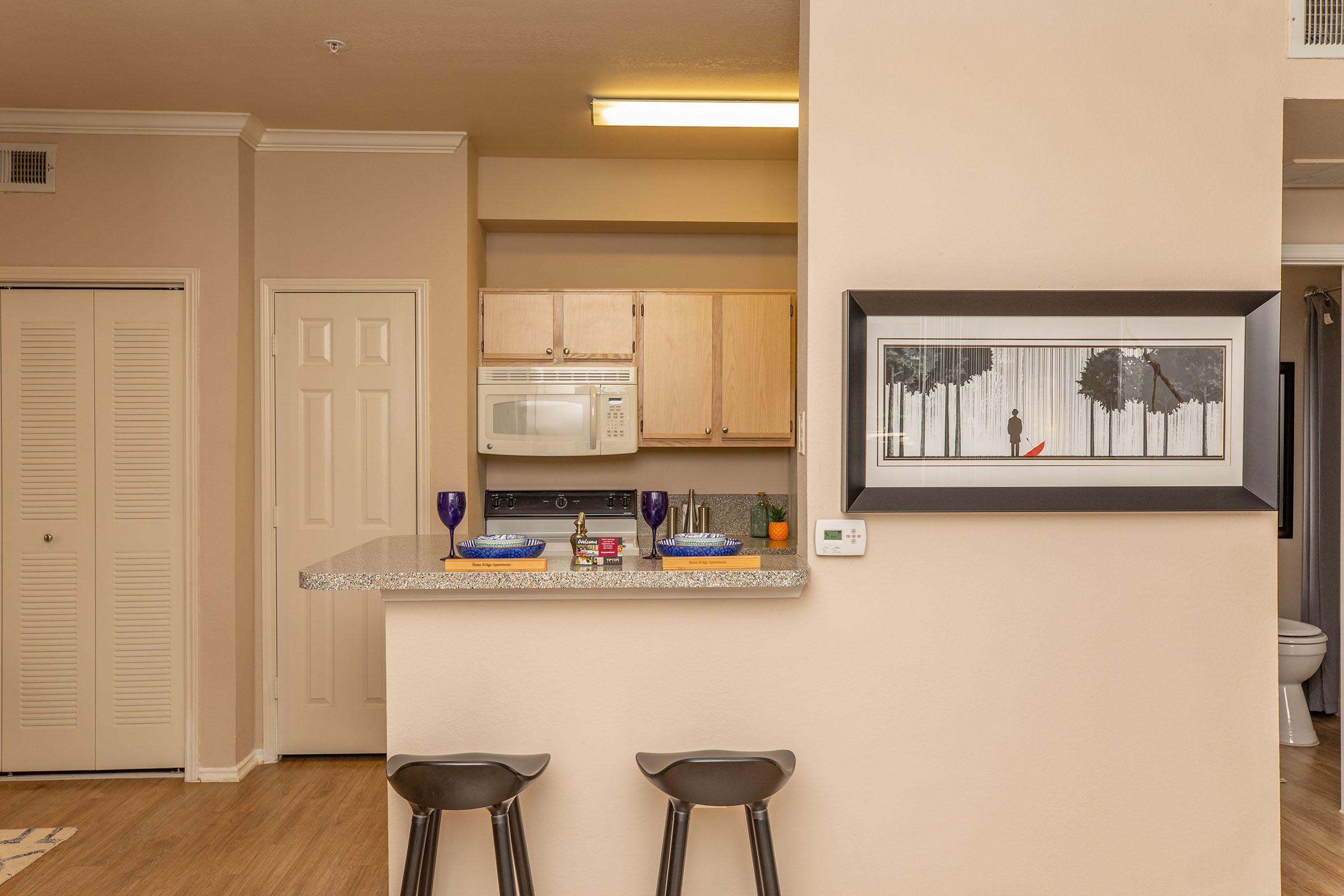 a kitchen with a painting