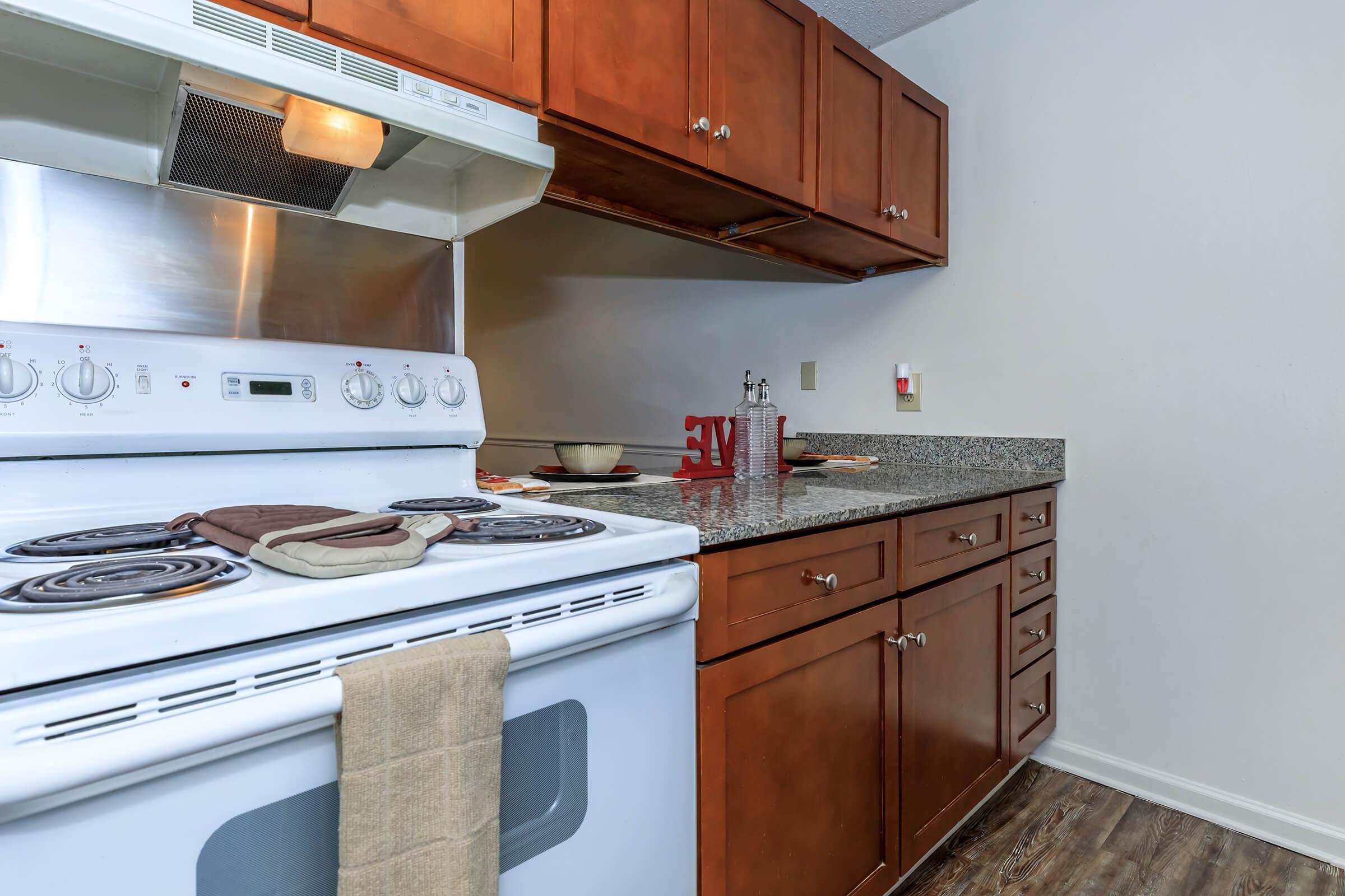 a stove top oven sitting inside of a kitchen