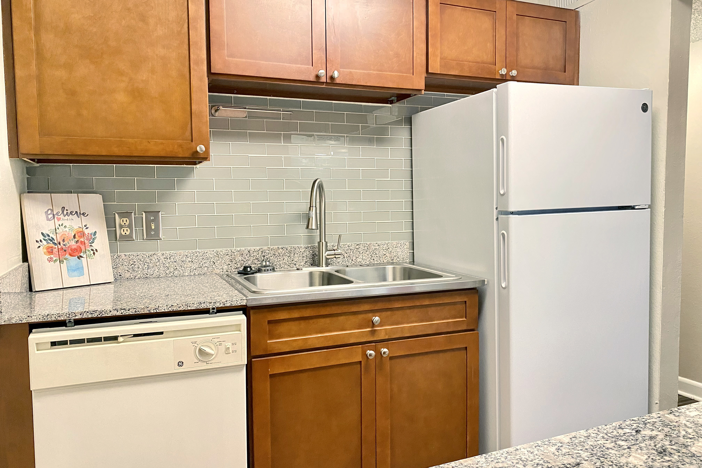 a kitchen with a stove and a refrigerator