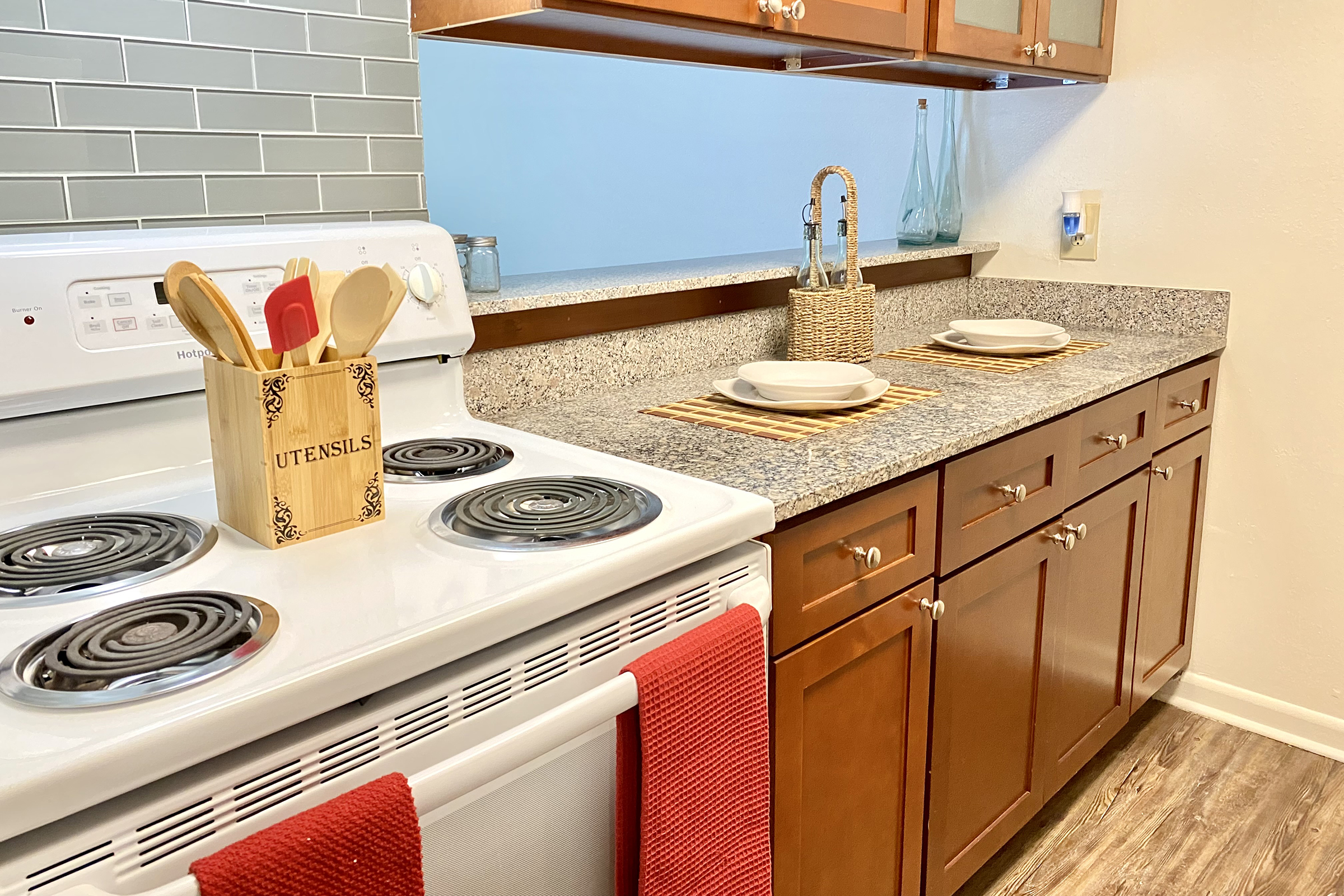 a stove top oven sitting inside of a kitchen