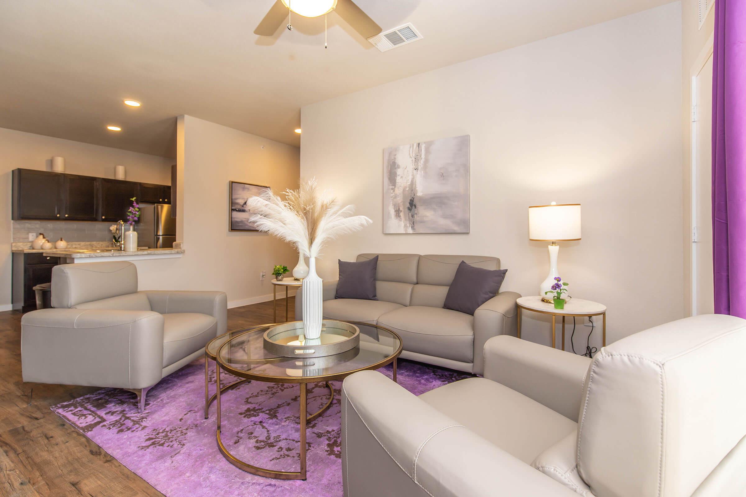 a living room filled with furniture and a flat screen tv