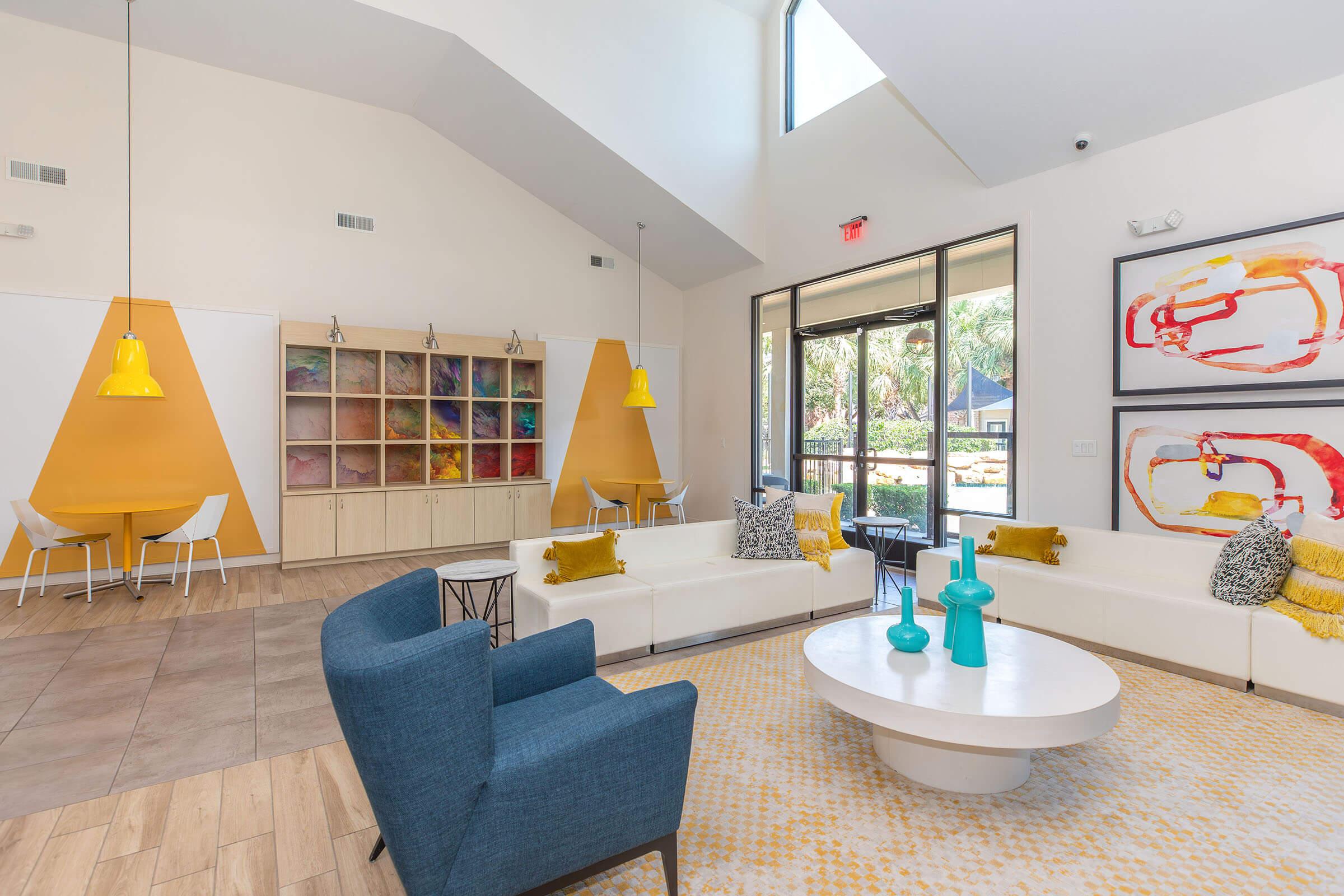 a living room filled with furniture and a large window