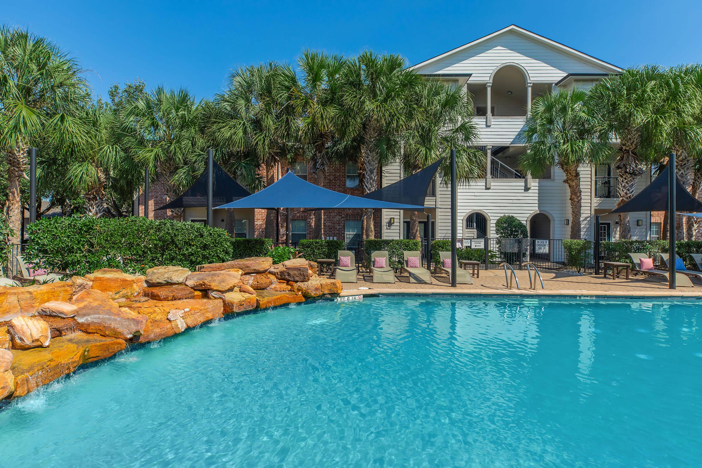 a large pool of water in front of a house