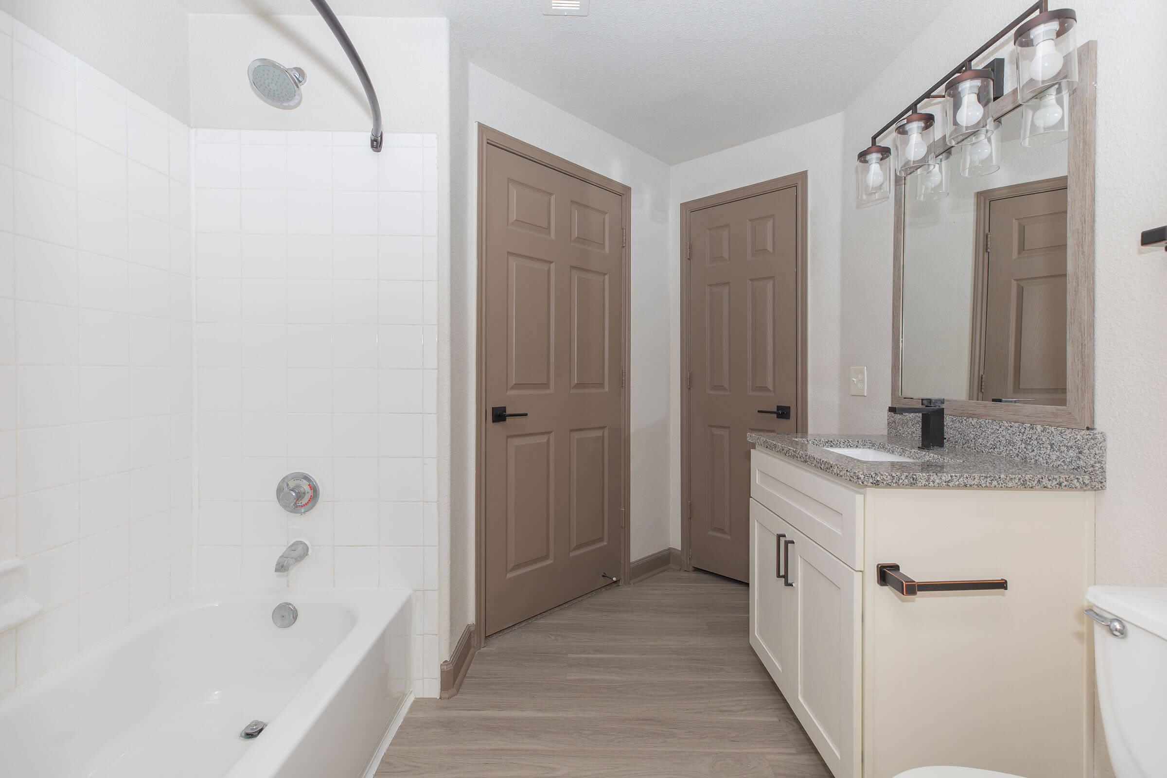 a kitchen with a sink and a mirror