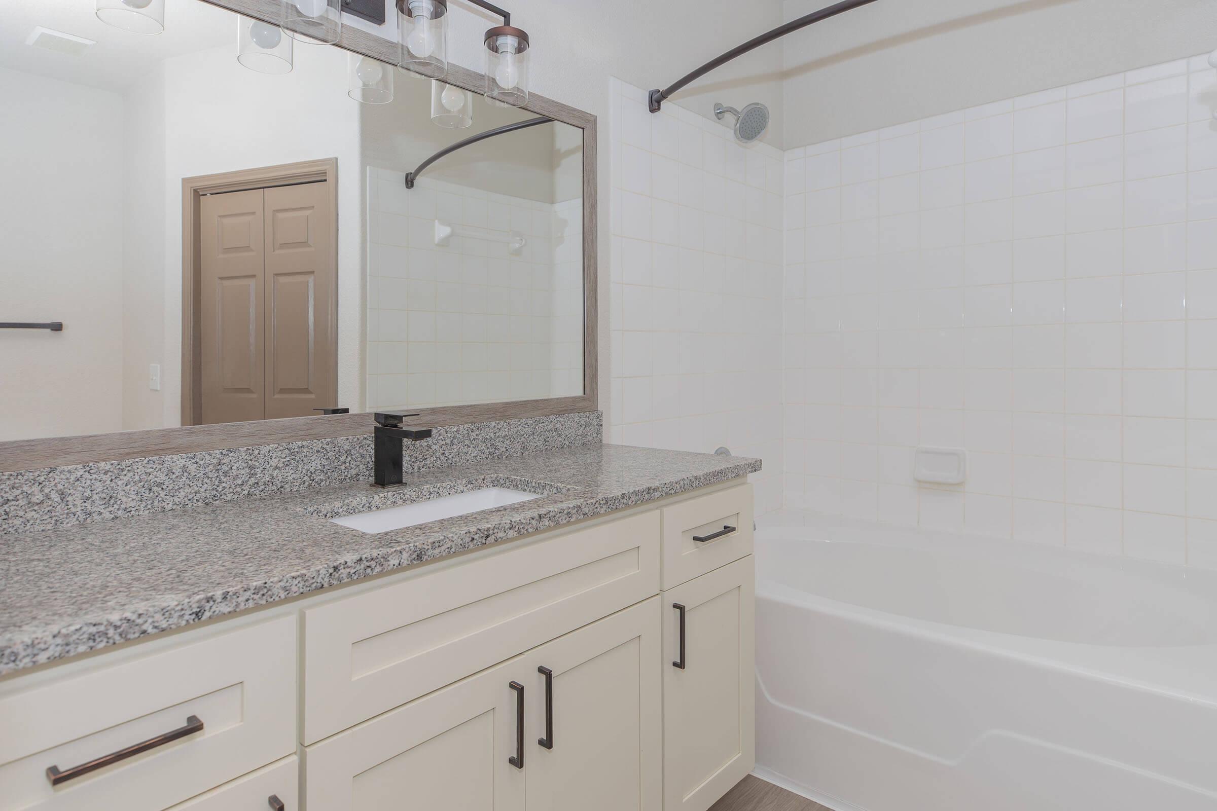 a kitchen with a sink and a mirror