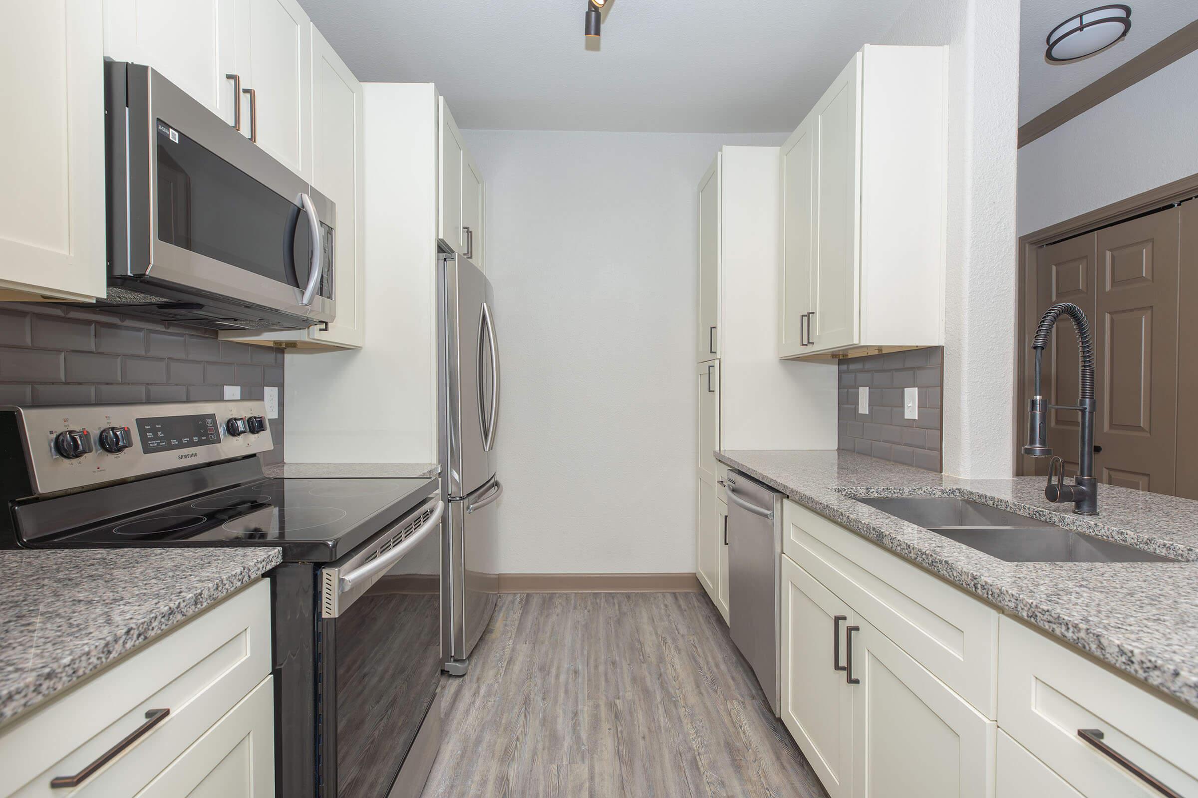 a kitchen with a sink and a microwave