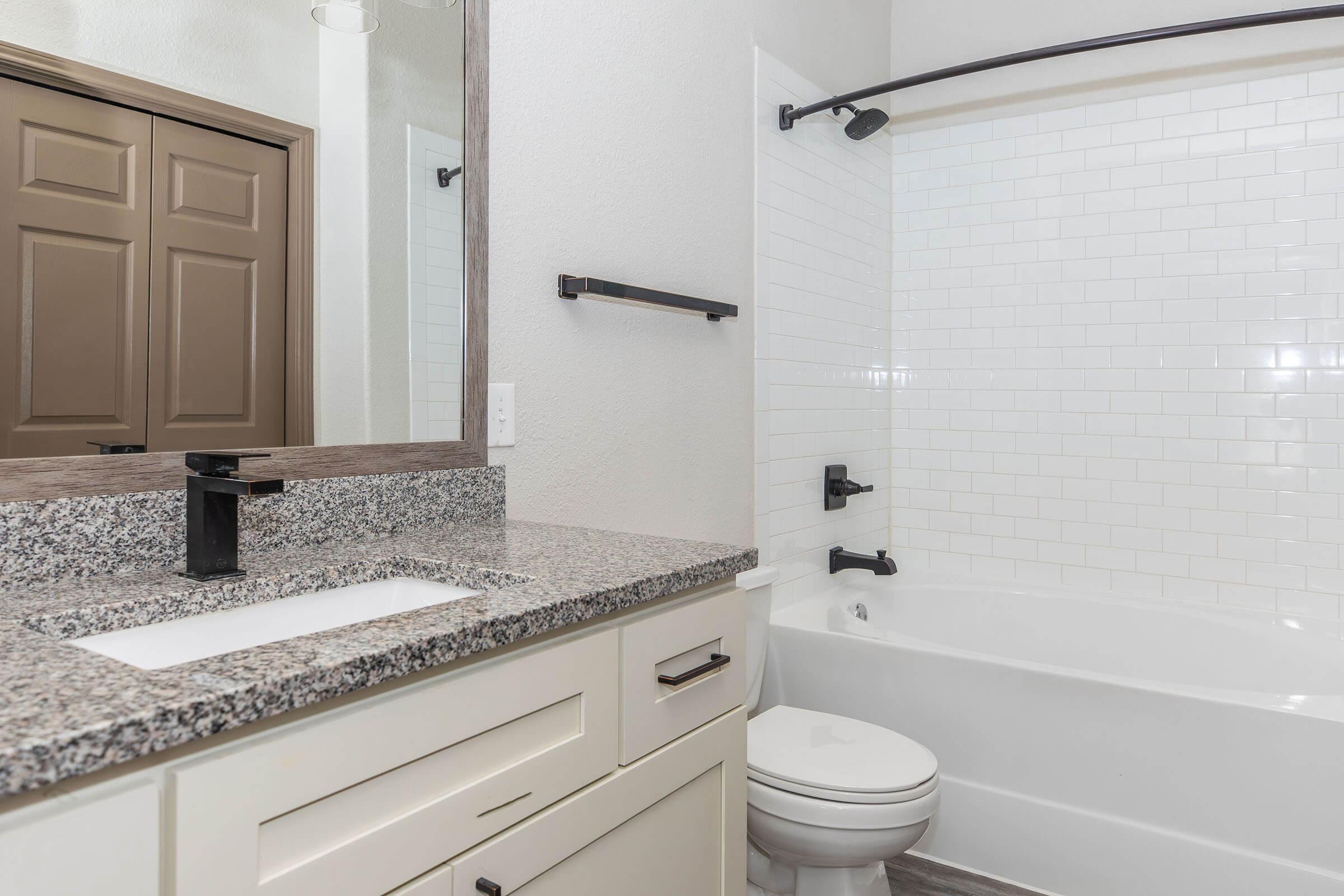 a kitchen with a sink and a mirror