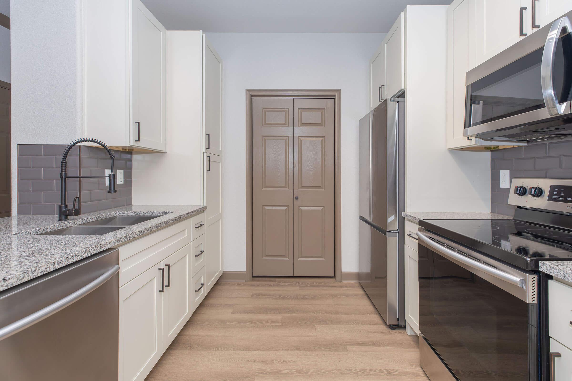 a kitchen with a stove and a sink