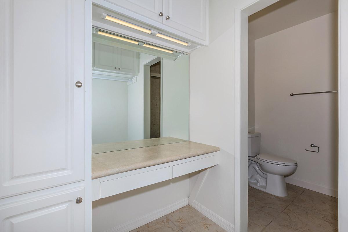 a white sink sitting under a window