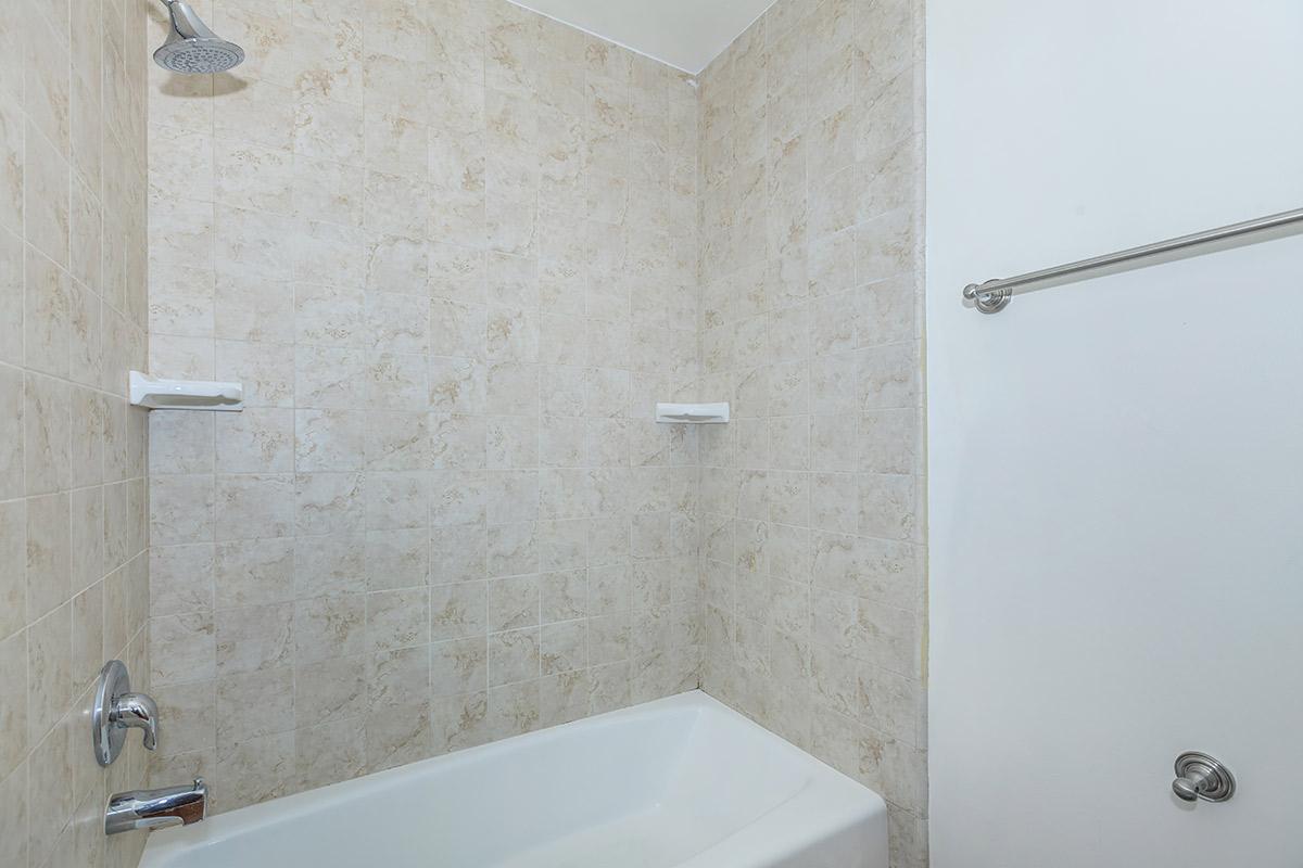 a white tub sitting next to a shower