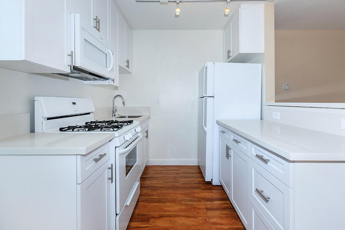 a kitchen with a white stove top oven