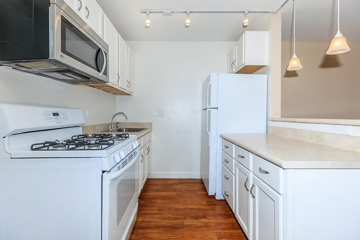 a white stove top oven sitting inside of a kitchen