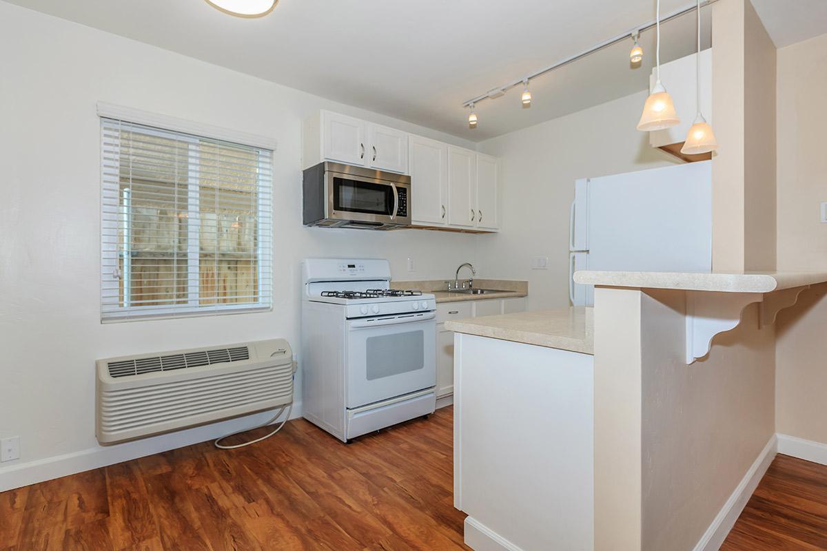 a kitchen with a hard wood floor