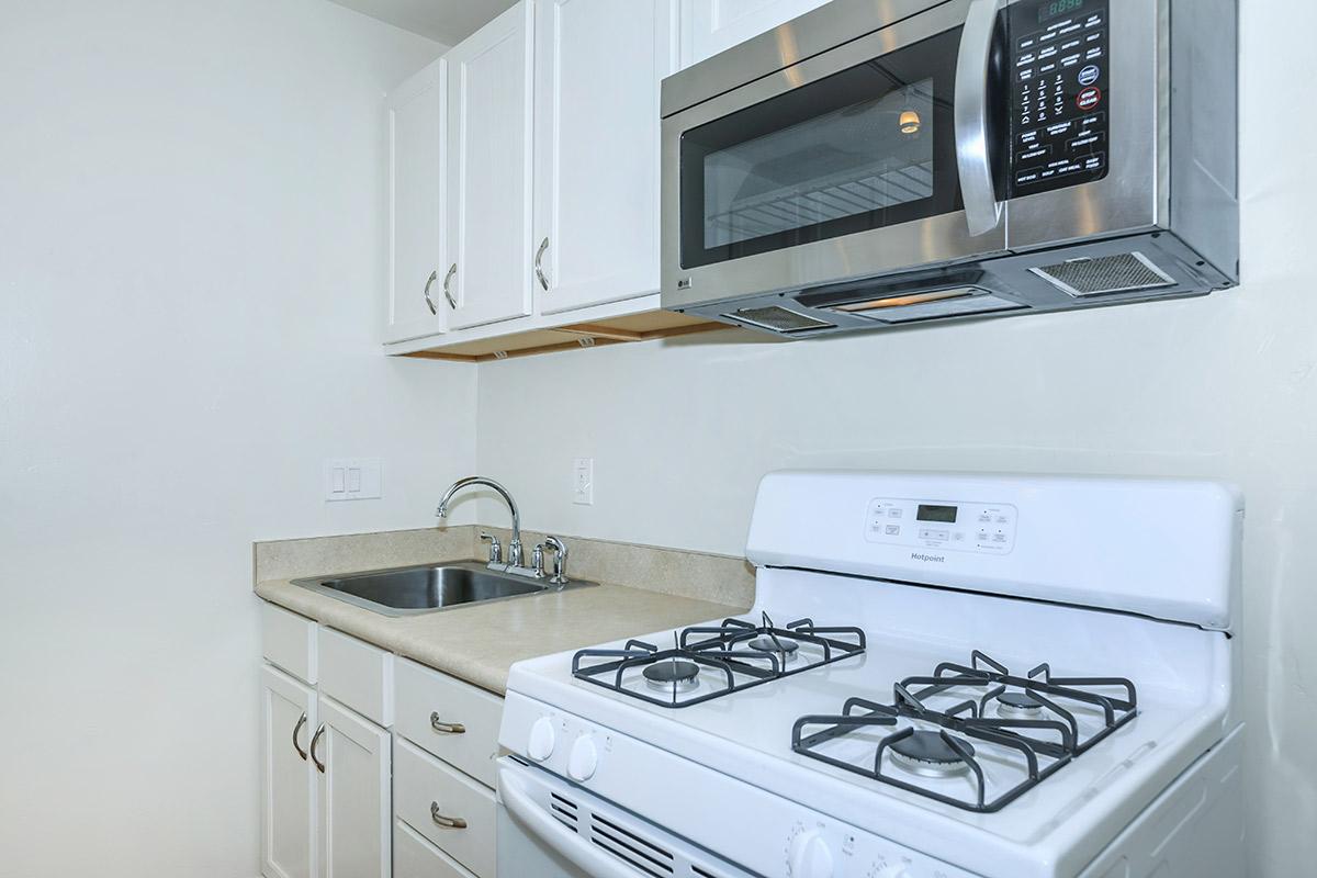 a white stove top oven sitting inside of a kitchen