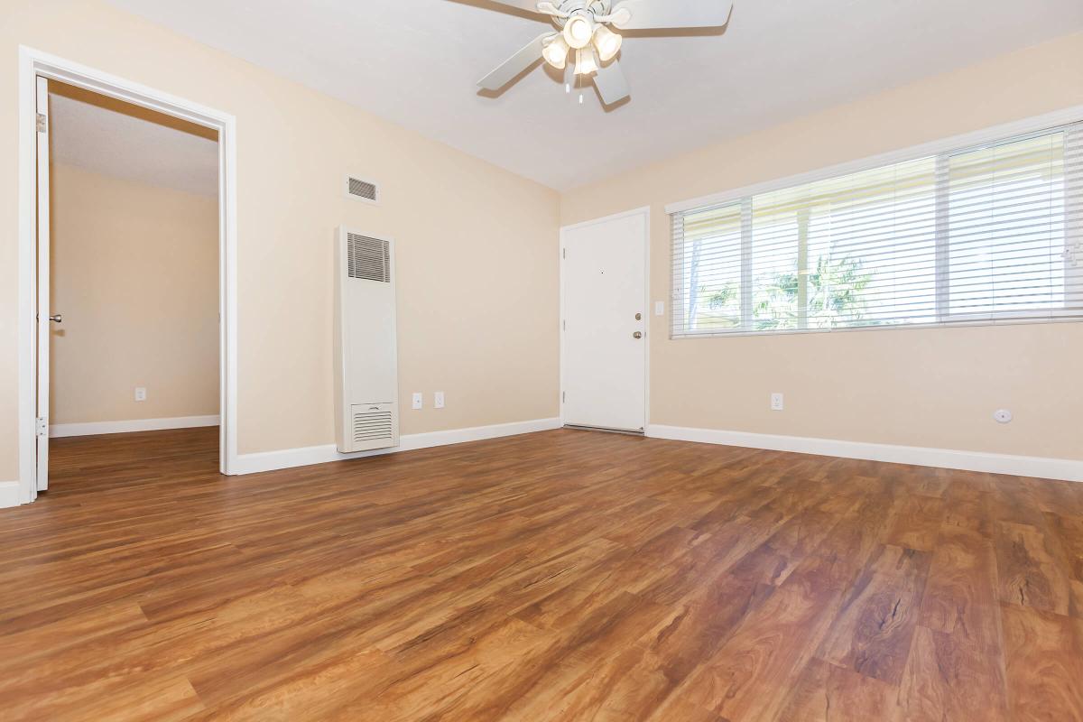 a close up of a hard wood floor next to a window