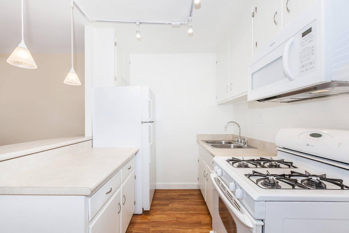 a kitchen with a white stove top oven