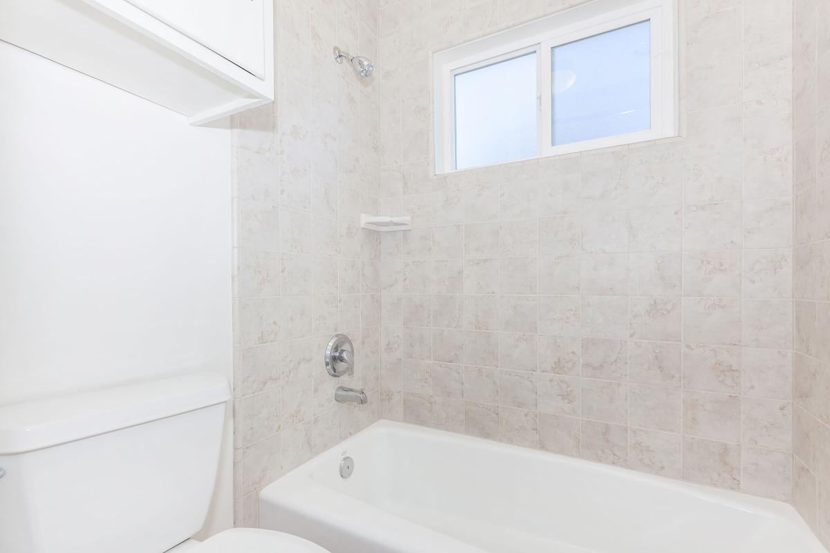 a white tub sitting next to a sink