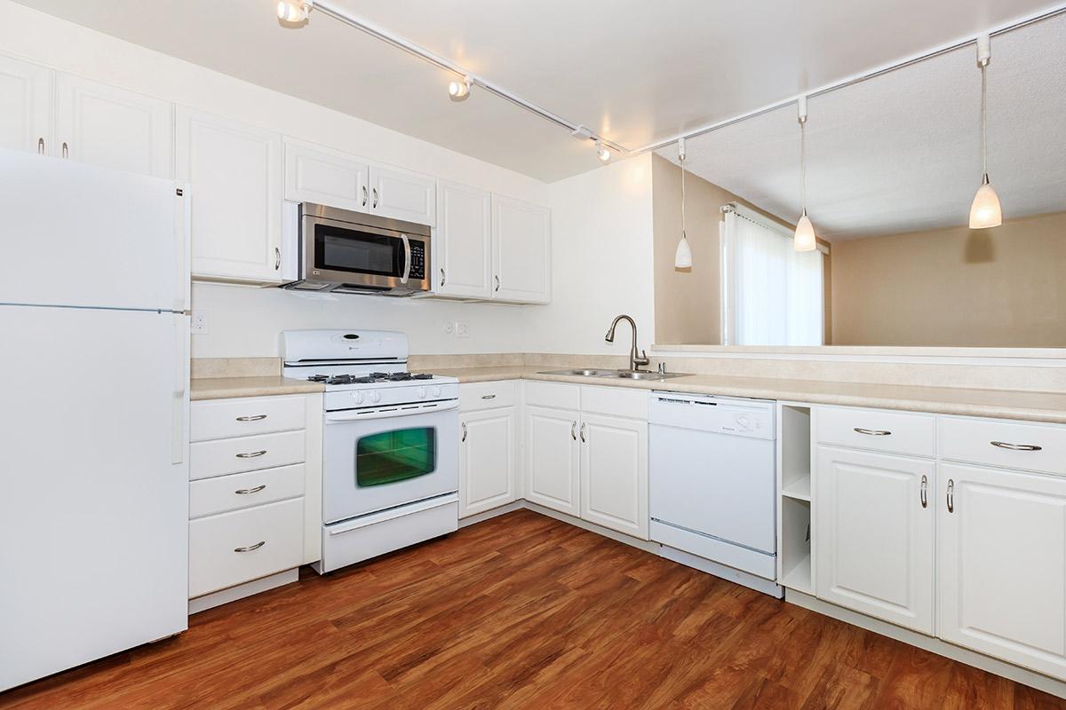 a large kitchen with white cabinets