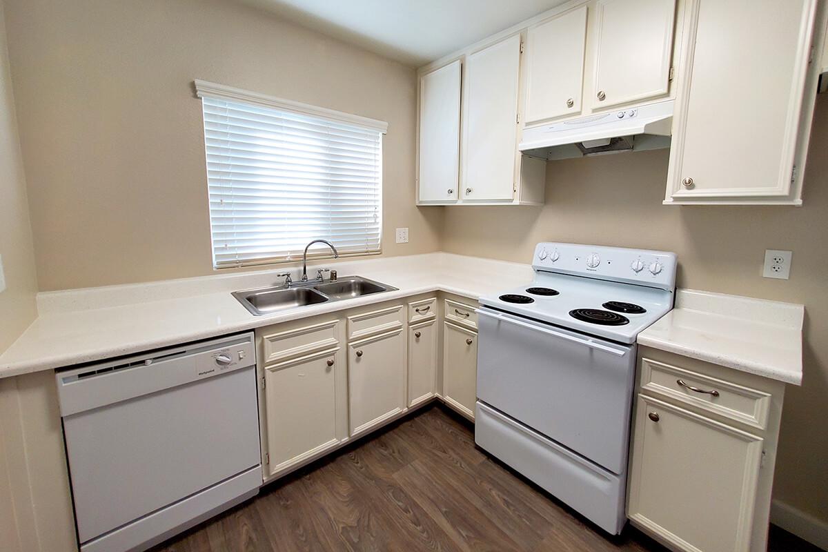 a kitchen with a stove a sink and a microwave