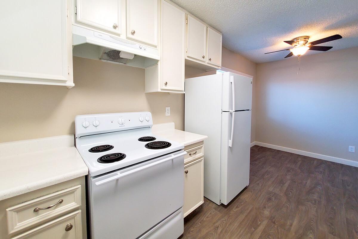 a stove top oven sitting inside of a kitchen