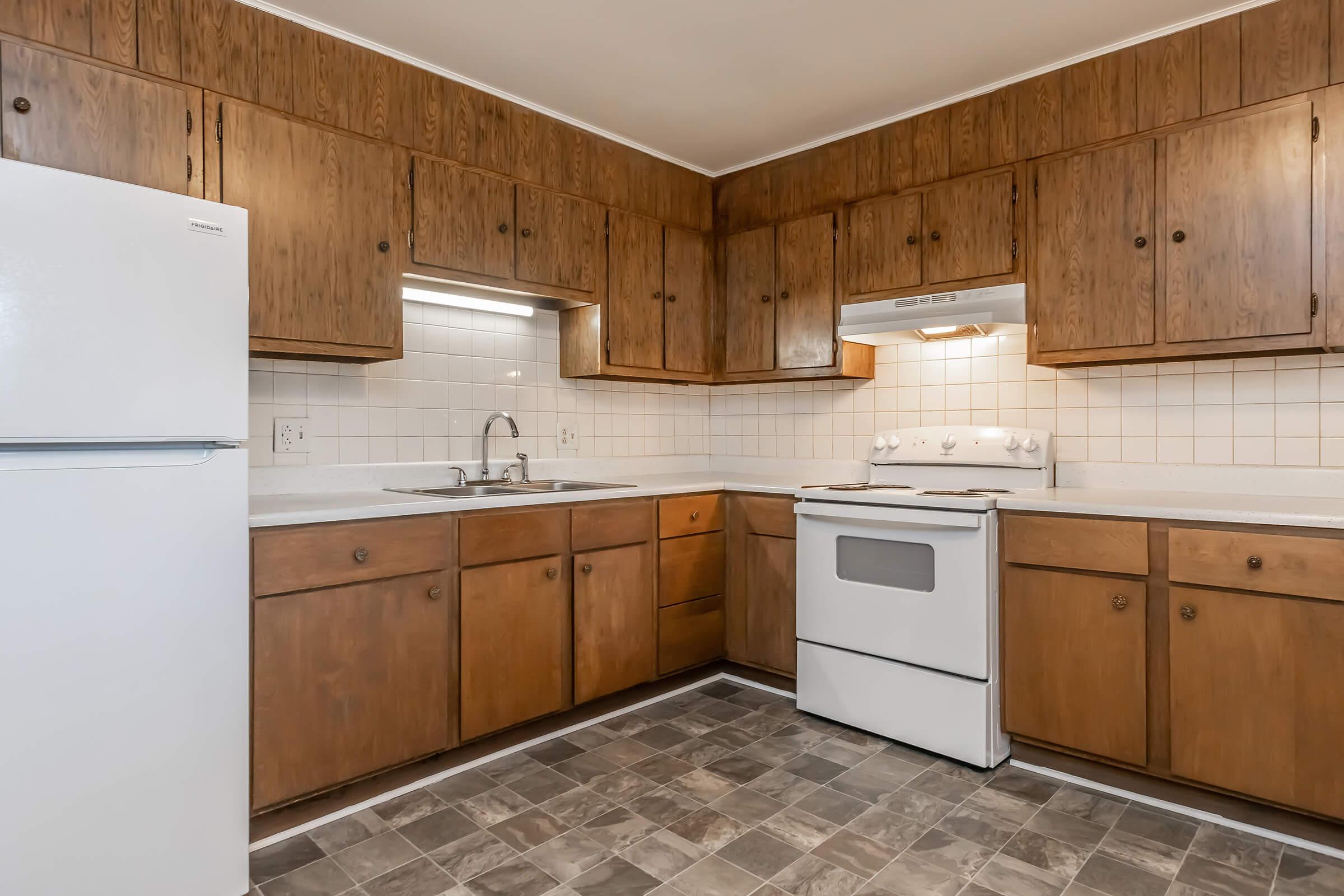 a kitchen with stainless steel appliances and wooden cabinets