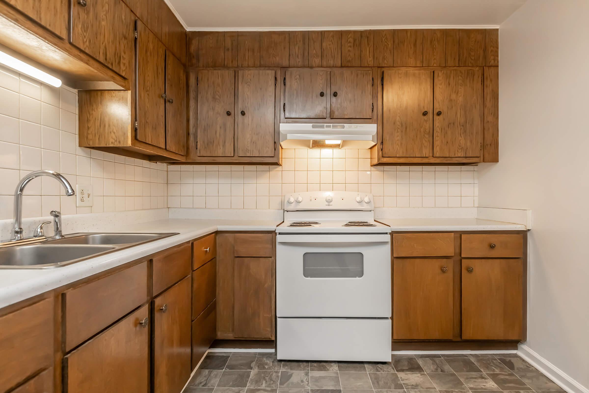 a kitchen with stainless steel appliances and wooden cabinets