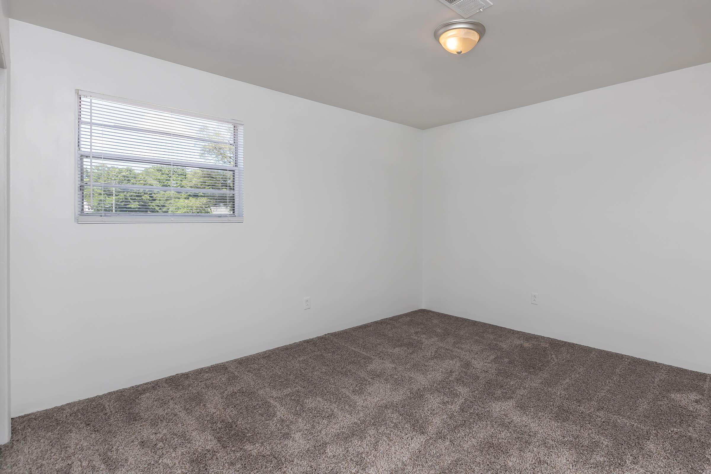 a bedroom with a large window