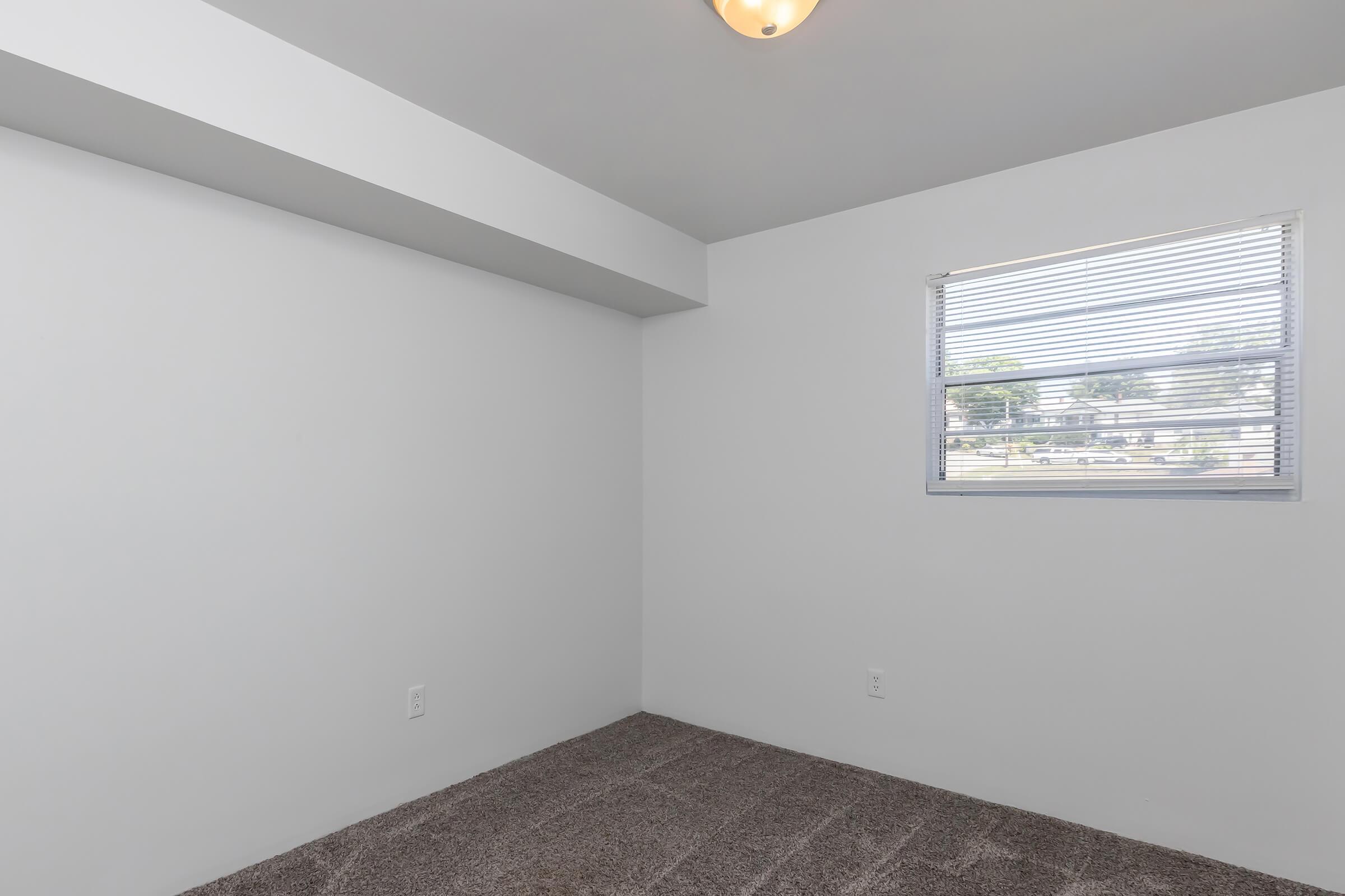 a bedroom with a large window