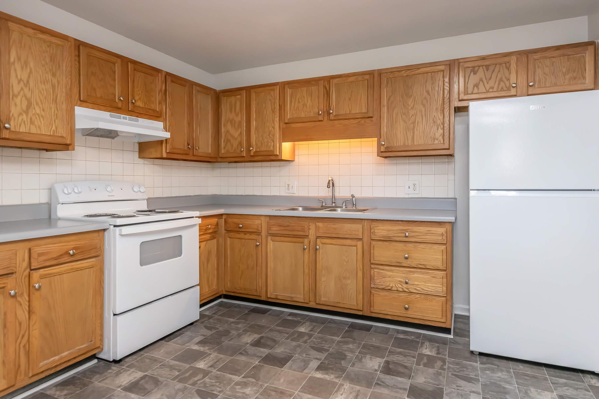 a kitchen with stainless steel appliances and wooden cabinets